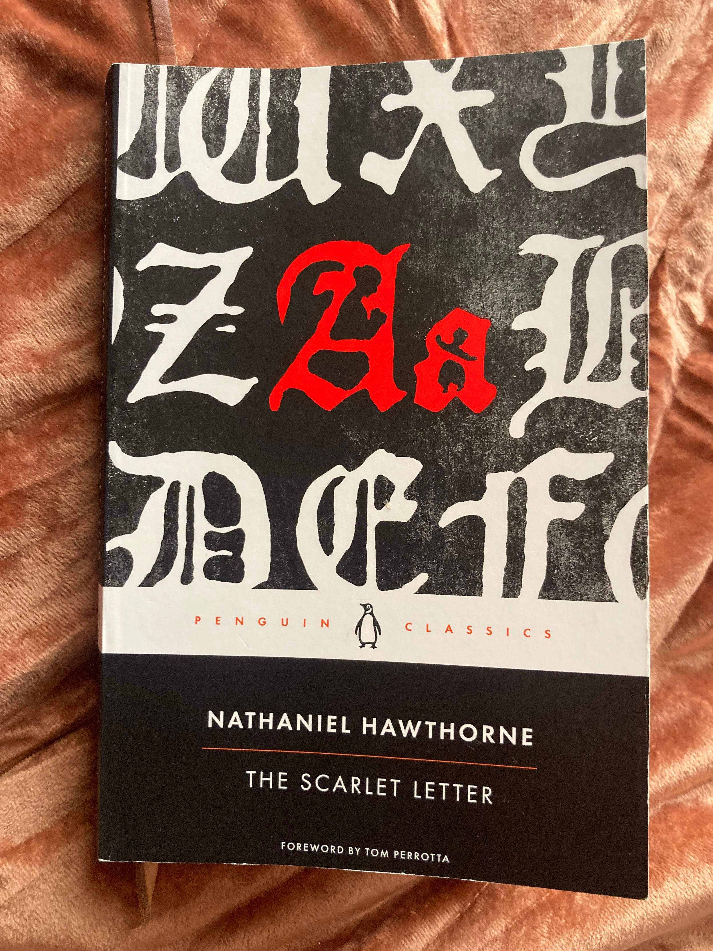 Book cover showing enlarged bits of old english text with “A a” in red at the center. In the characters’ negative spaces are images of mother and child.