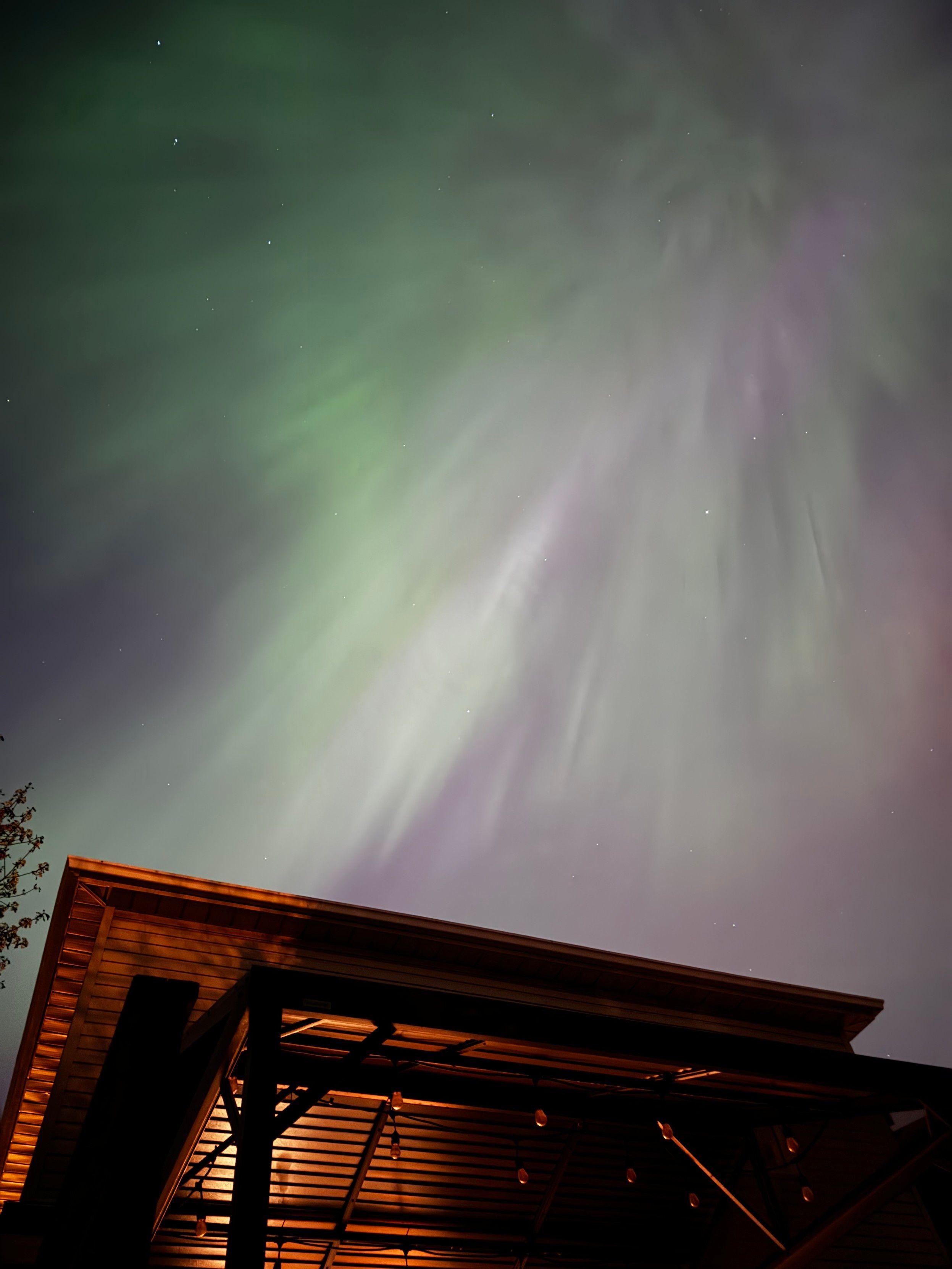 Aurora borealis next to a house