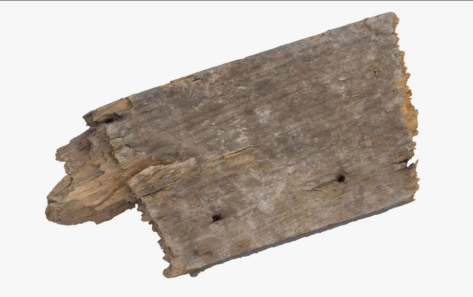 A weathered piece of an old wooden board.