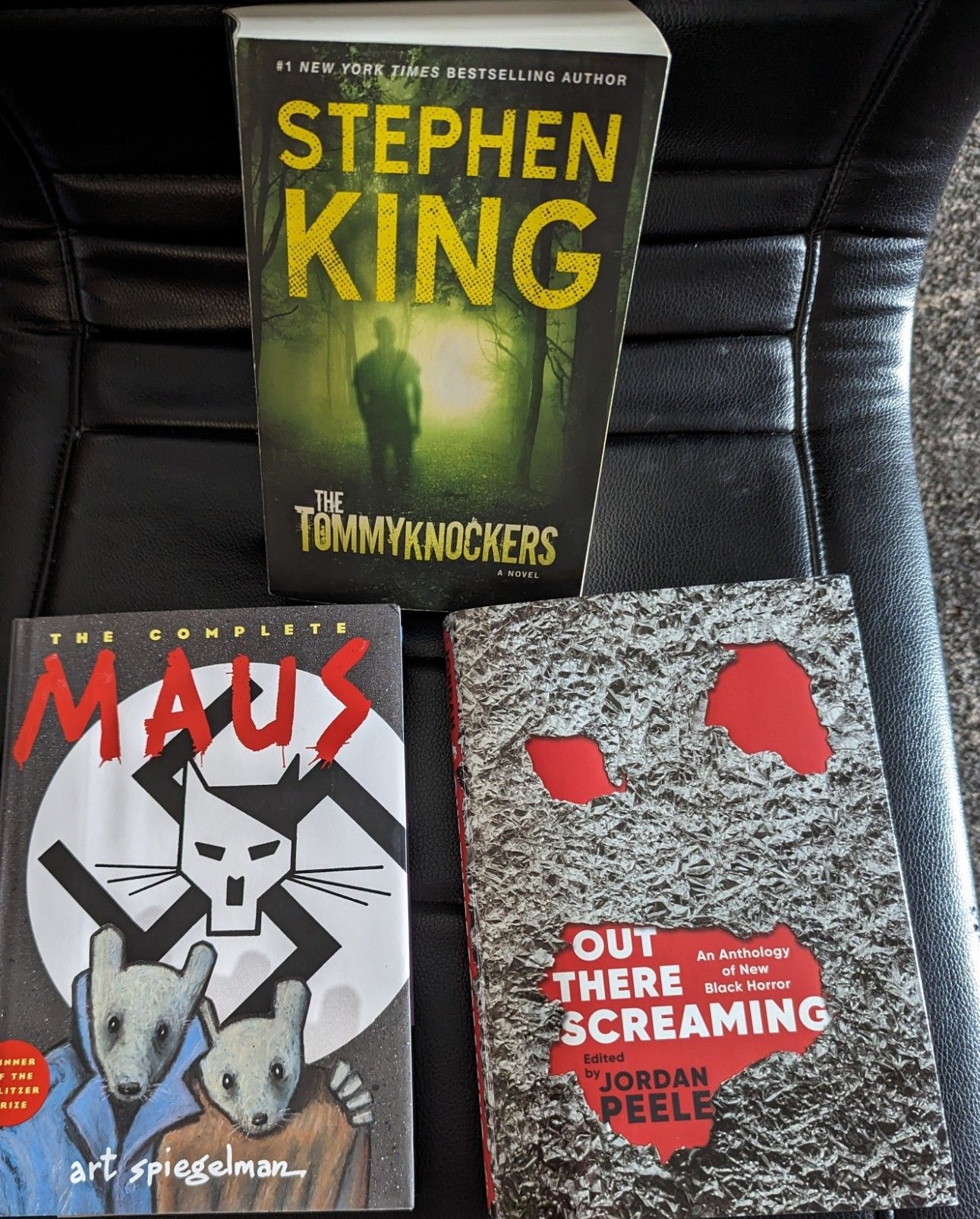 Picture of books I got on vacation.  Paperback of Tommyknockers by Stephen King, Maus by Art Spiegelman, and Out There Screaming, an Anthology of New Black Horror Stories.