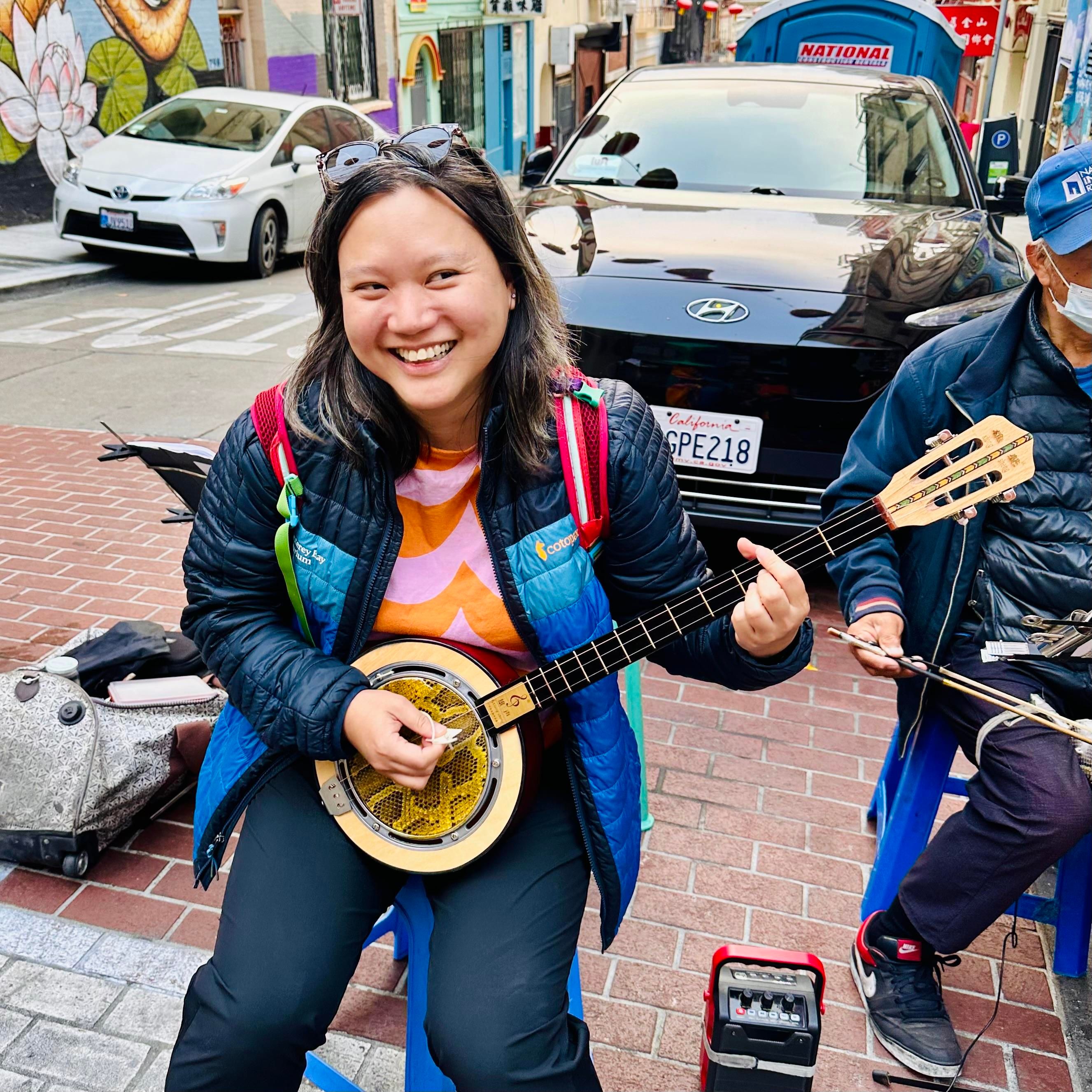 A photo of me smiling a lot while strumming 