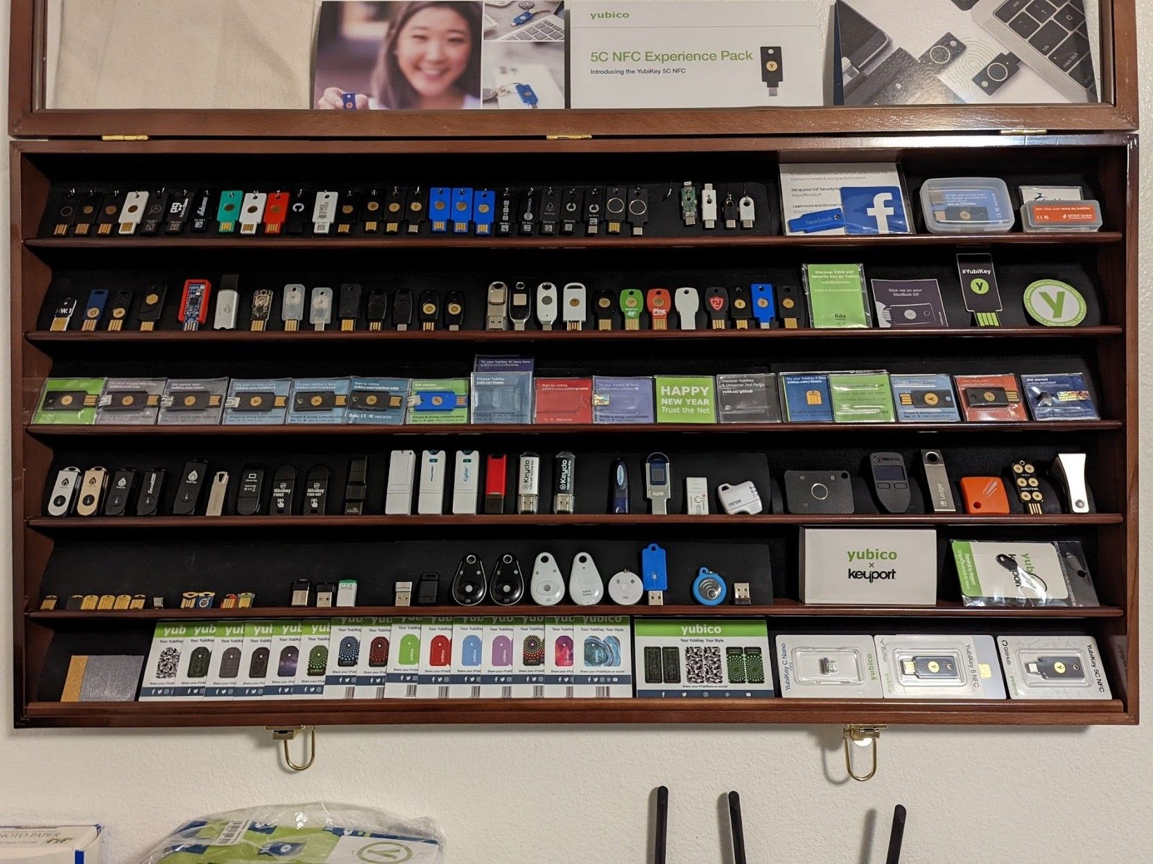 Five rows of security keys in a wall-mounted case. Approximately 20 keys or ephemera per row.