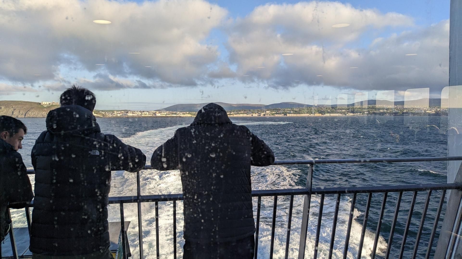 People standing on small outside area while leaving the islands