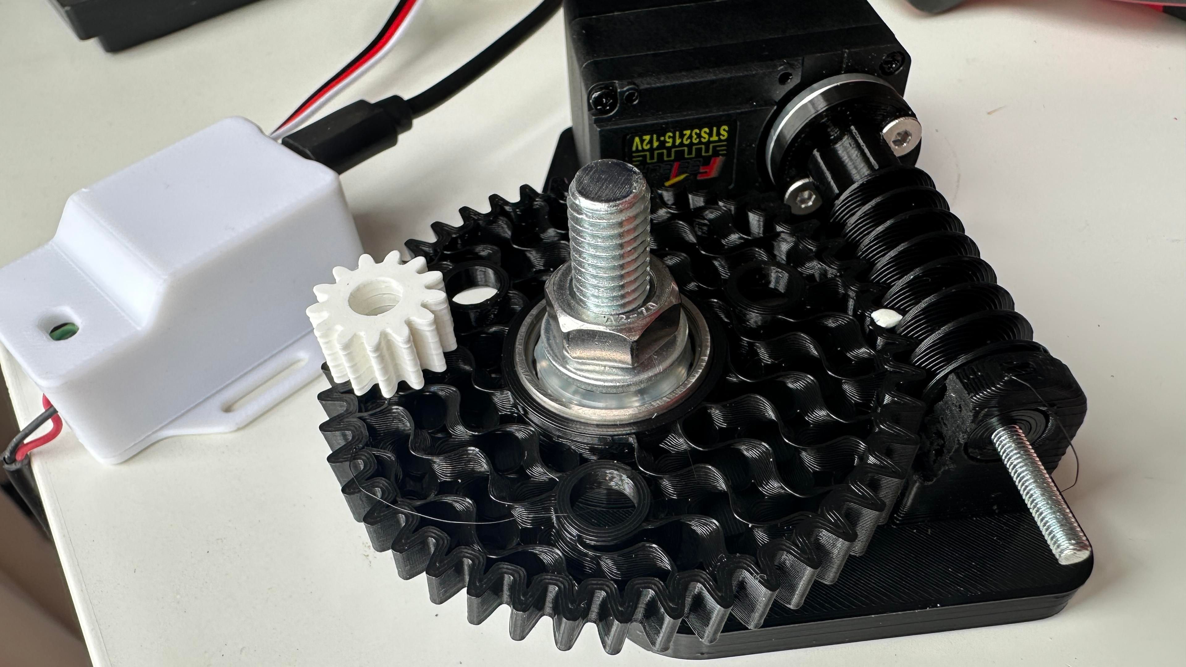 Black 3D printed worm and helix gears with white dots drawn on them to see the rotation. 