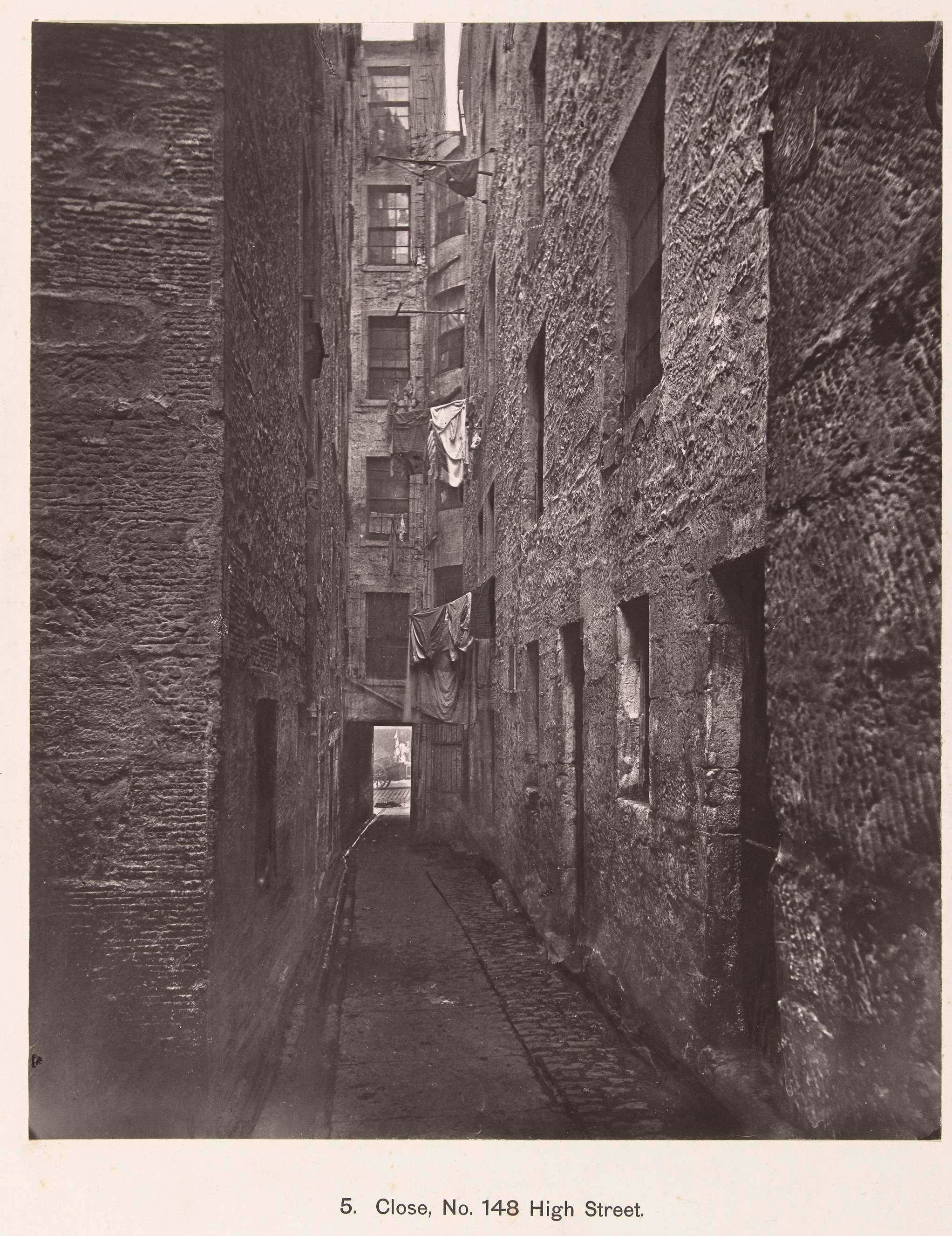 View of a narrow passage between tenements.
