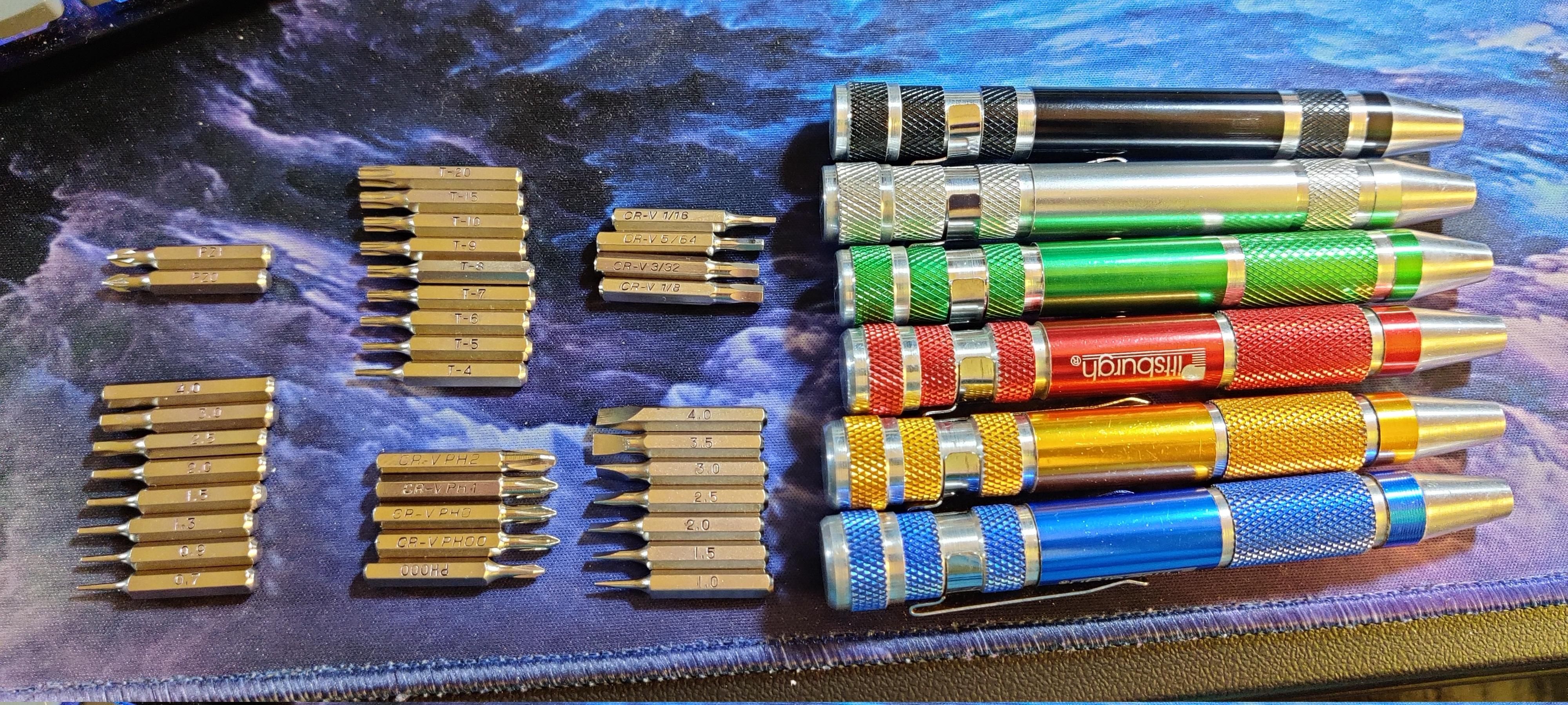 Six cheap aluminum bit holders ("screwdrivers") and six rows of small screwdriver bits; phillips, pozidrive, flat-head, torx, and two groups of hex bits. If you look closely enough, you'll see that they're ordered by the size stamped onto them, are clearly from multiple sources.