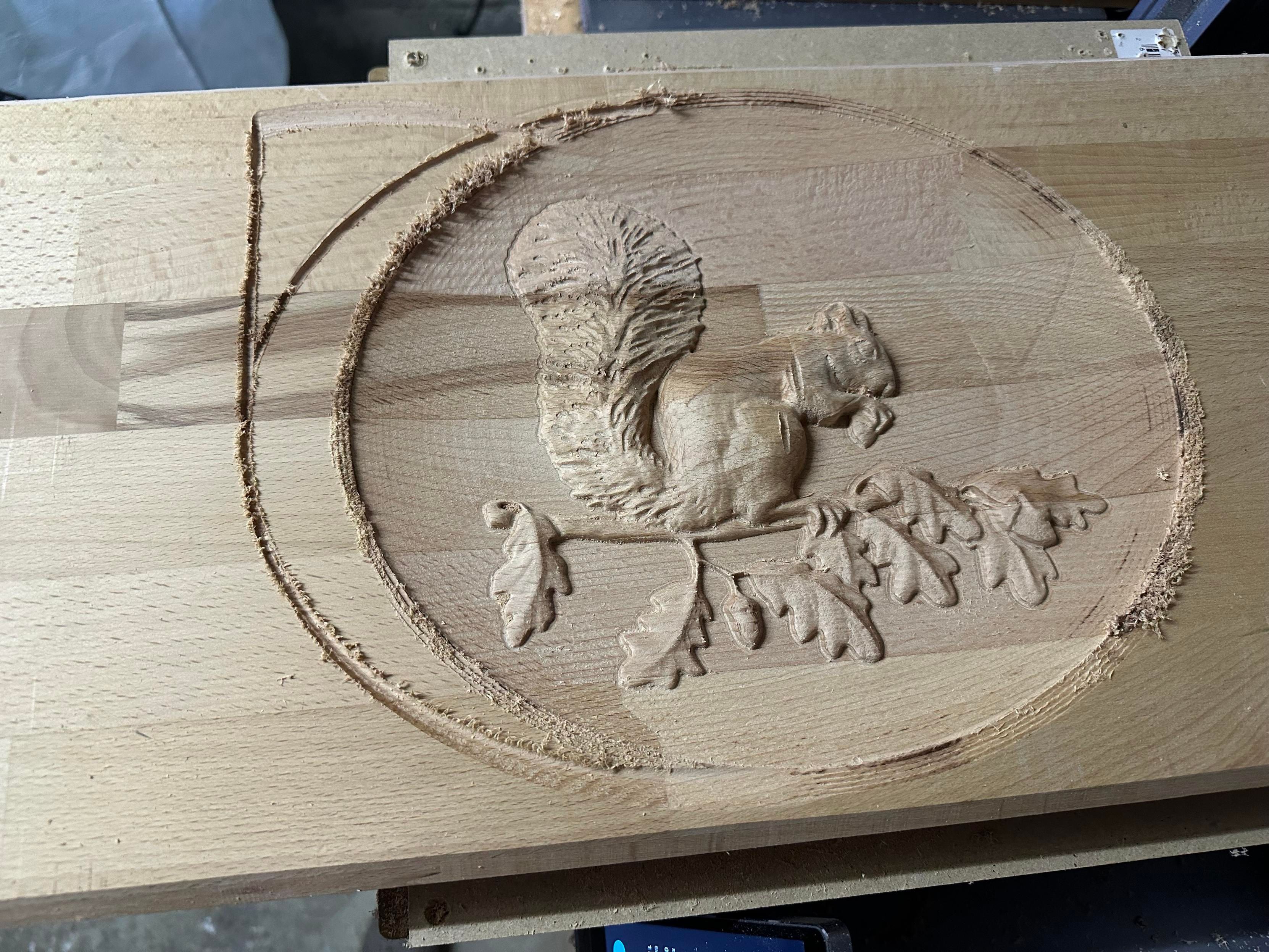squirrel engraving via CNC where the CNC bit's position got offset by about 3 cm to the left on the last few layers and ground out a new path outside where it was supposed to go
