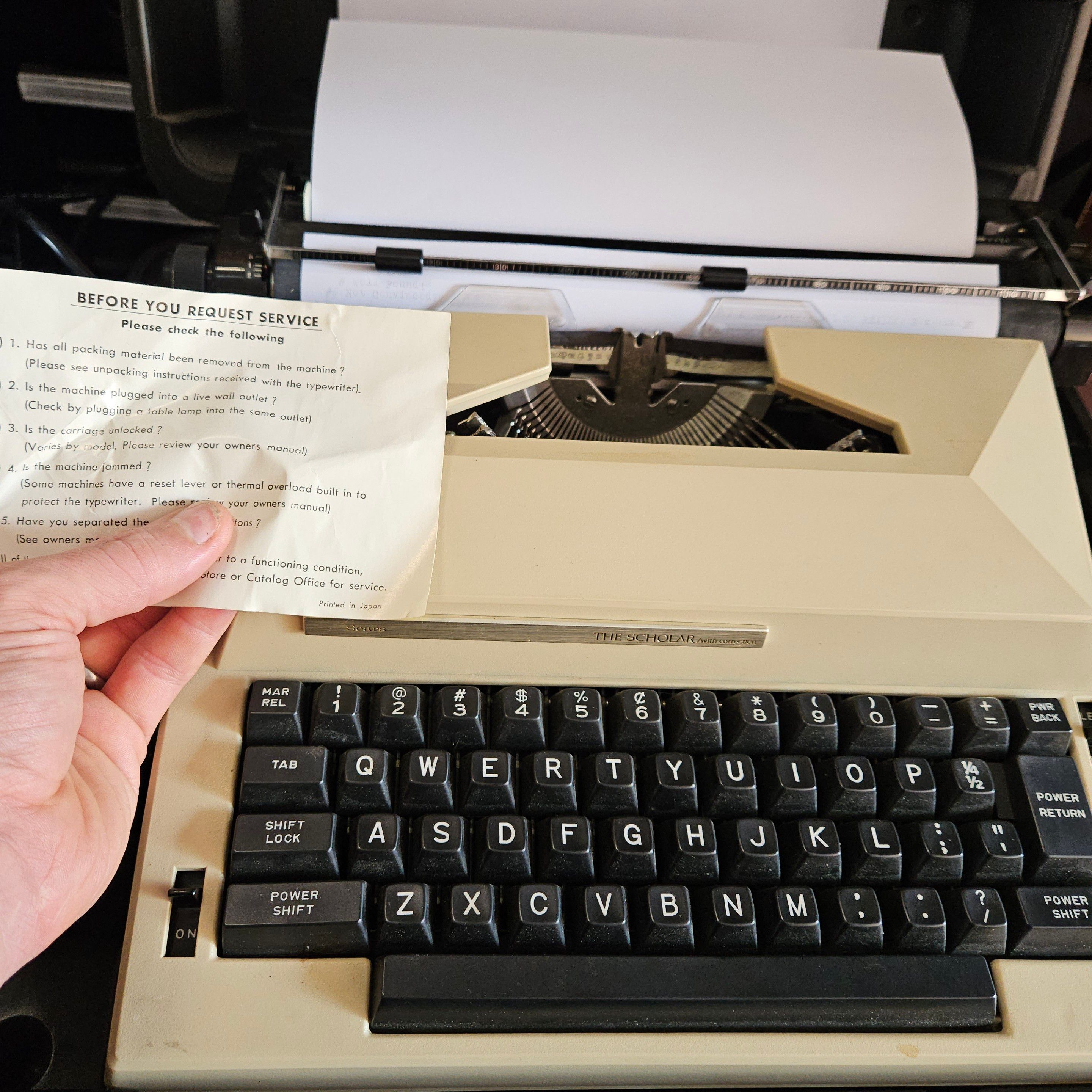 a Sears typewriter, "The Scholar" with the original service reminder card inside.
