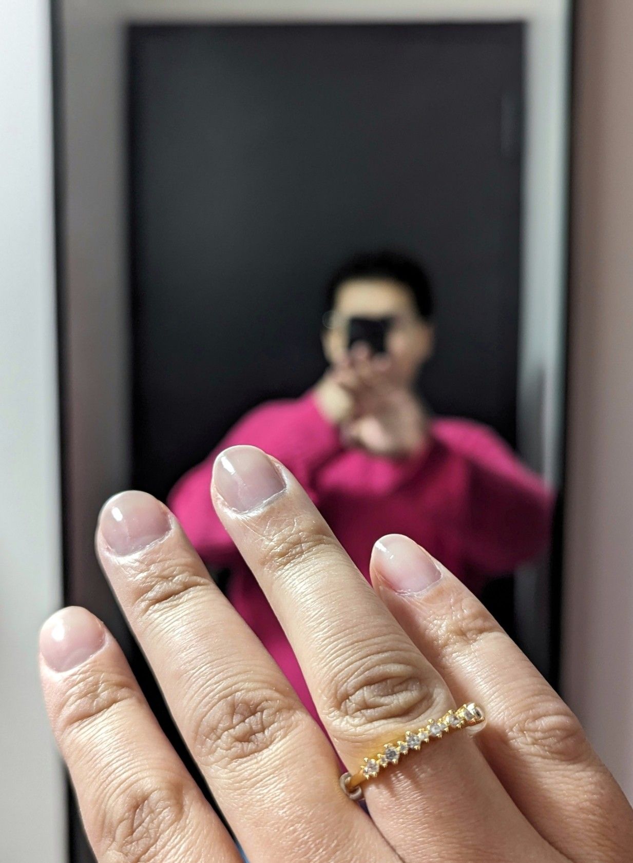 Jo taking a selfie in the mirror, and showing off her nails.