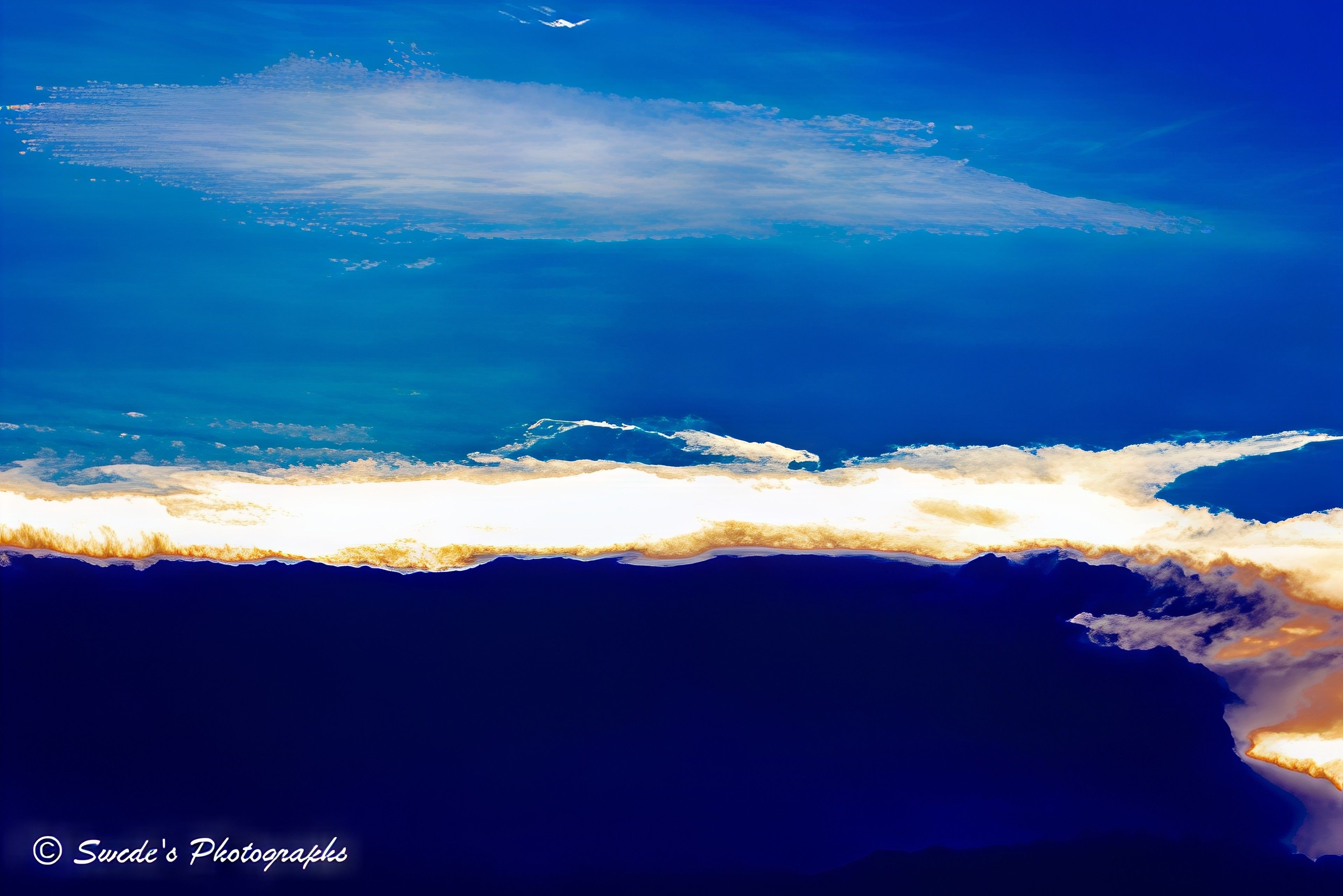 Between The Heavens

"The sky in this image is a living canvas—an expansive dome brushed with bold strokes of deep sapphire and soft cerulean. Billowing clouds drift across the scene like luminous sculptures, their edges kissed by sunlight that makes them glow with ethereal brilliance. Some clouds are thick and cottony, casting gentle shadows, while others are wispy and feathered, dissolving into the blue like breath on glass.

The sunlight doesn’t just illuminate—it transforms. It carves radiant pathways through the cloudscape, creating a dynamic interplay of light and shadow that evokes both serenity and awe. The contrast between the brilliant whites and the rich blues is dramatic, like a symphony of color and atmosphere.

There’s a sense of movement, as if the sky is slowly shifting, breathing, alive. The image feels like a moment suspended in time—an invitation to pause and marvel at the quiet grandeur above.

In the bottom left corner, the artist’s signature, “© Swede’s Photographs,” anchors the image with a personal touch, reminding us that this fleeting beauty was captured through a human lens." - Copilot
