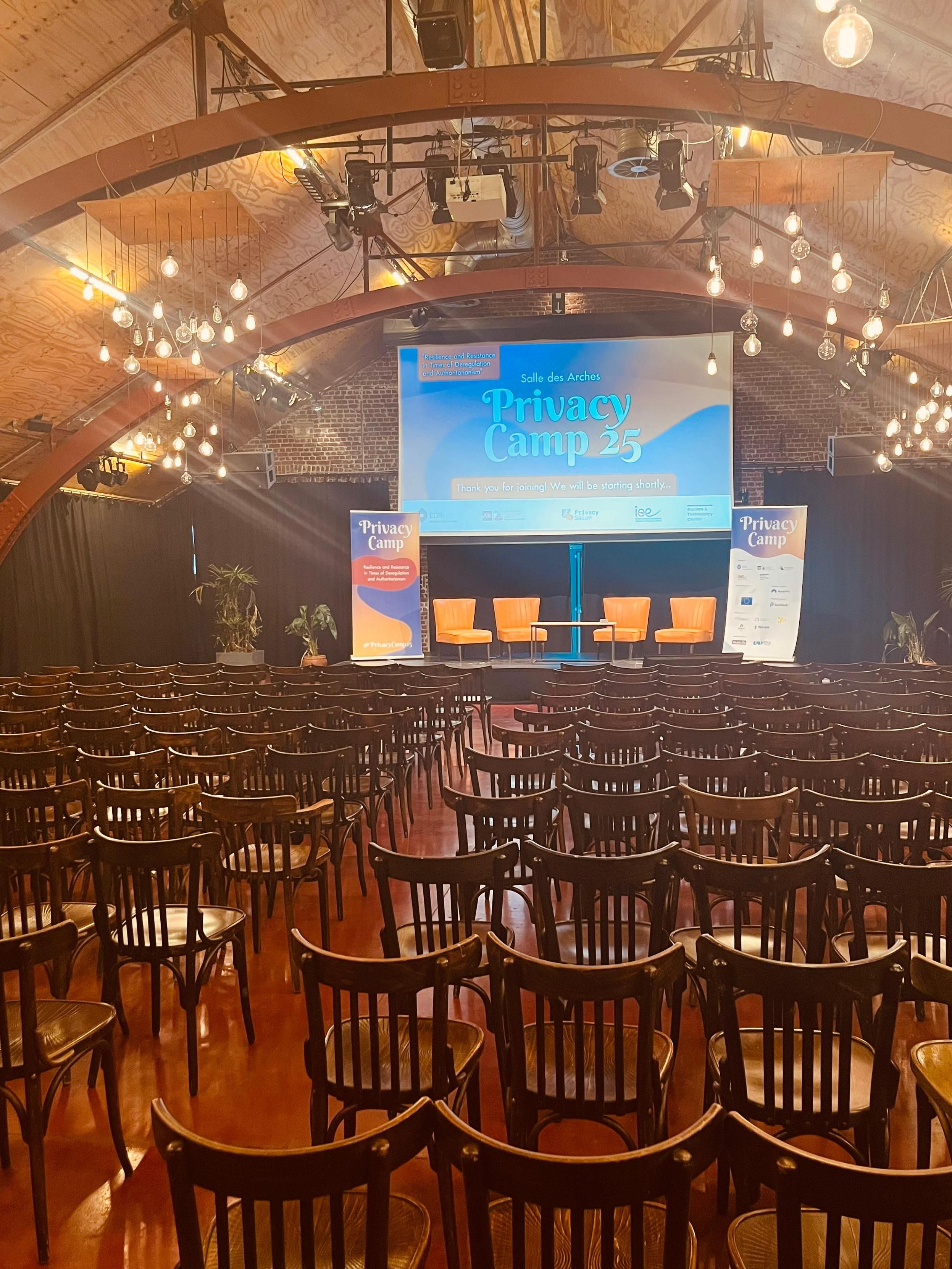 Room with screen projecting Privacy Camp logo and theme for this year's edition