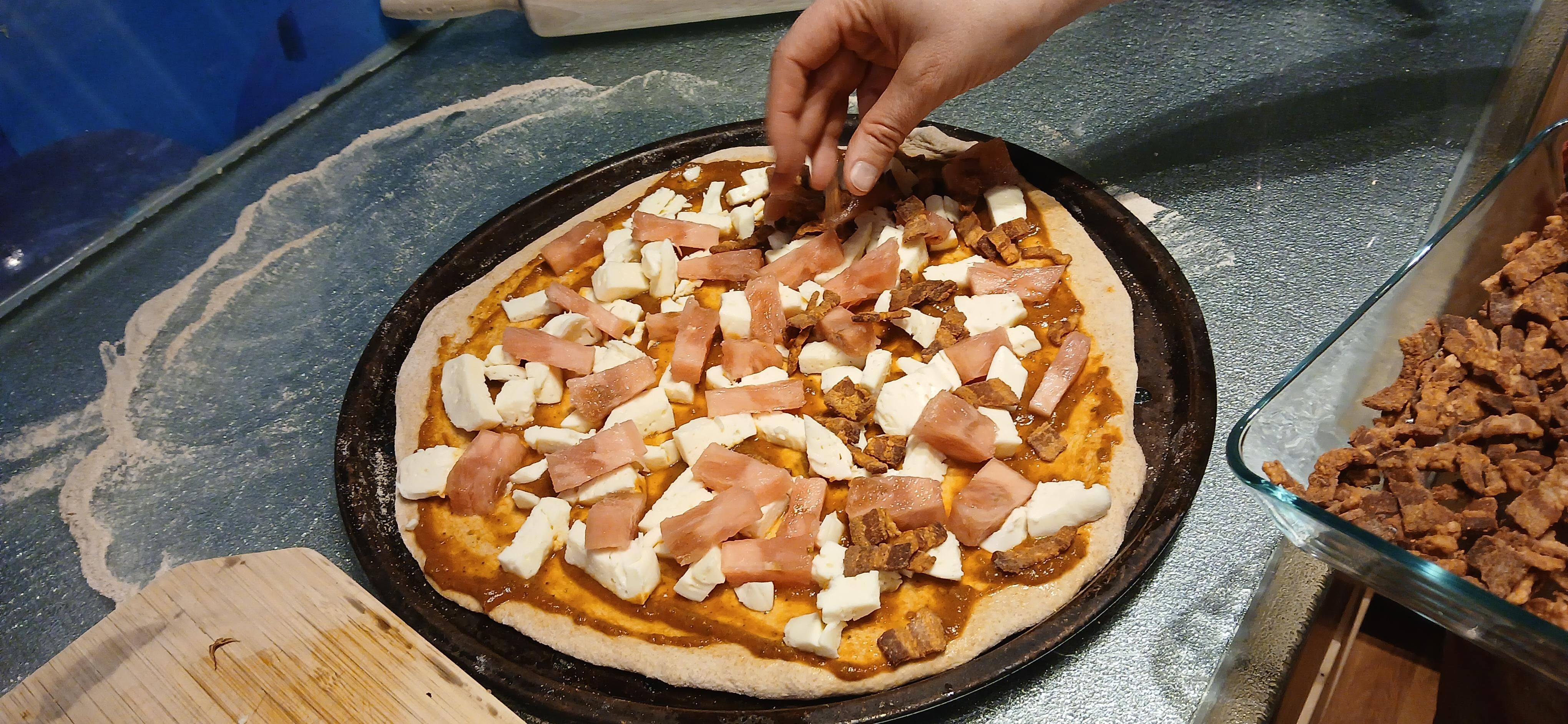 Unbaked pizza on counter