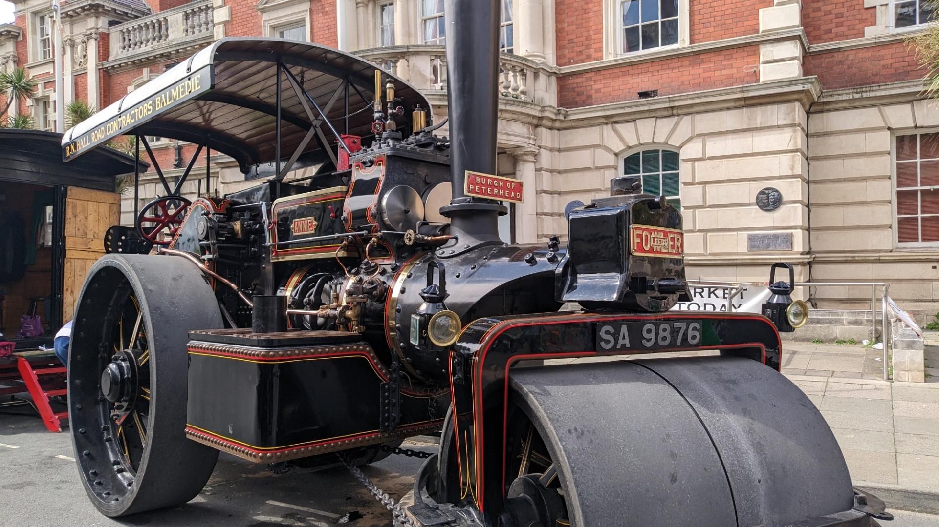 Large old black coal powered steamroller