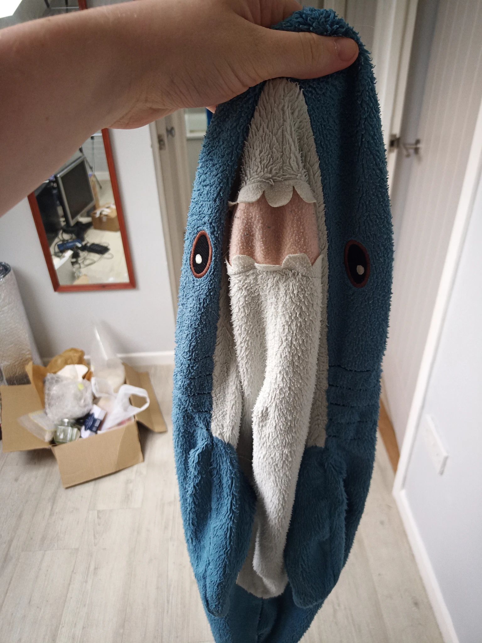 Me holding the blahaj's ... uh .... skin? I removed their stuffing and washed them