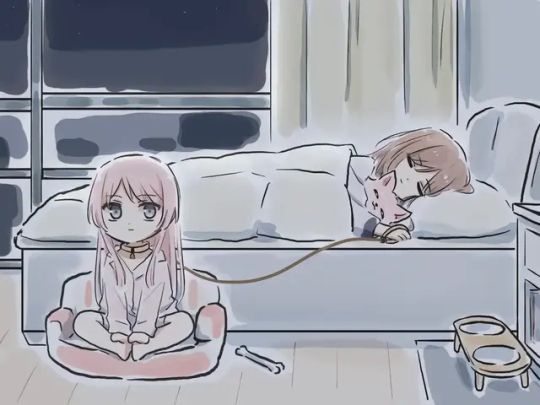 the other girl is sat on a dog bed next to the bed, collared and leashed to the first girls hand