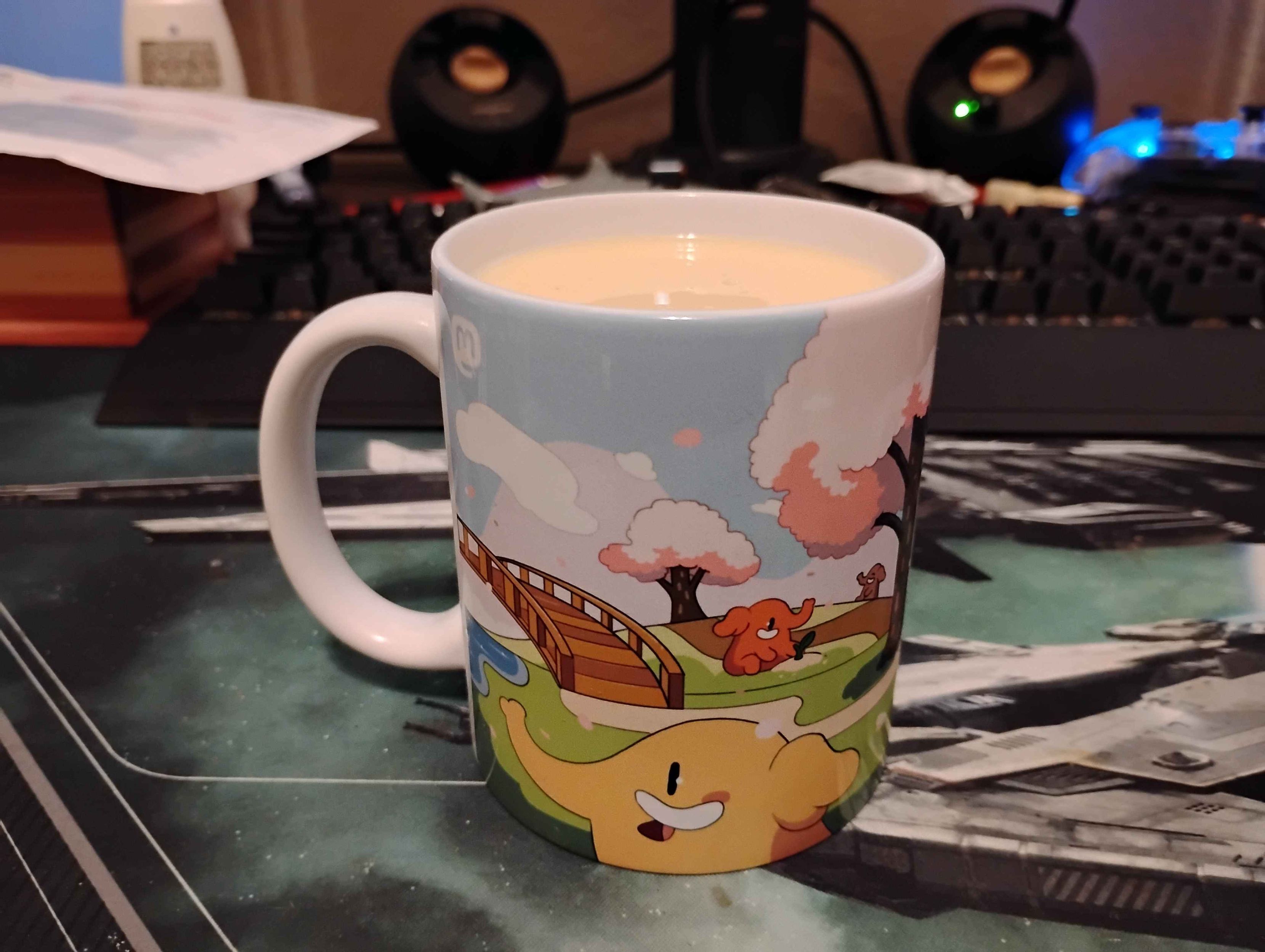 Image of a coffee or tea cup showing off the other side of the Mastodon Cherry Blossom Mug filled with eggnog.