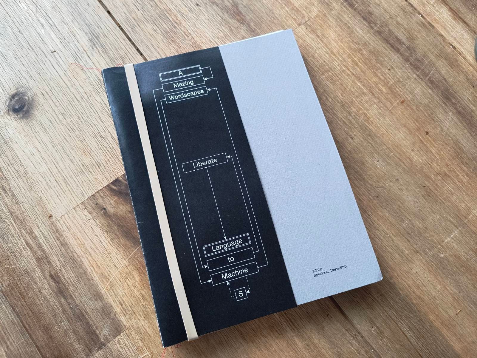 Photo of the booklet: a black cover with the title, and a grey subcover.