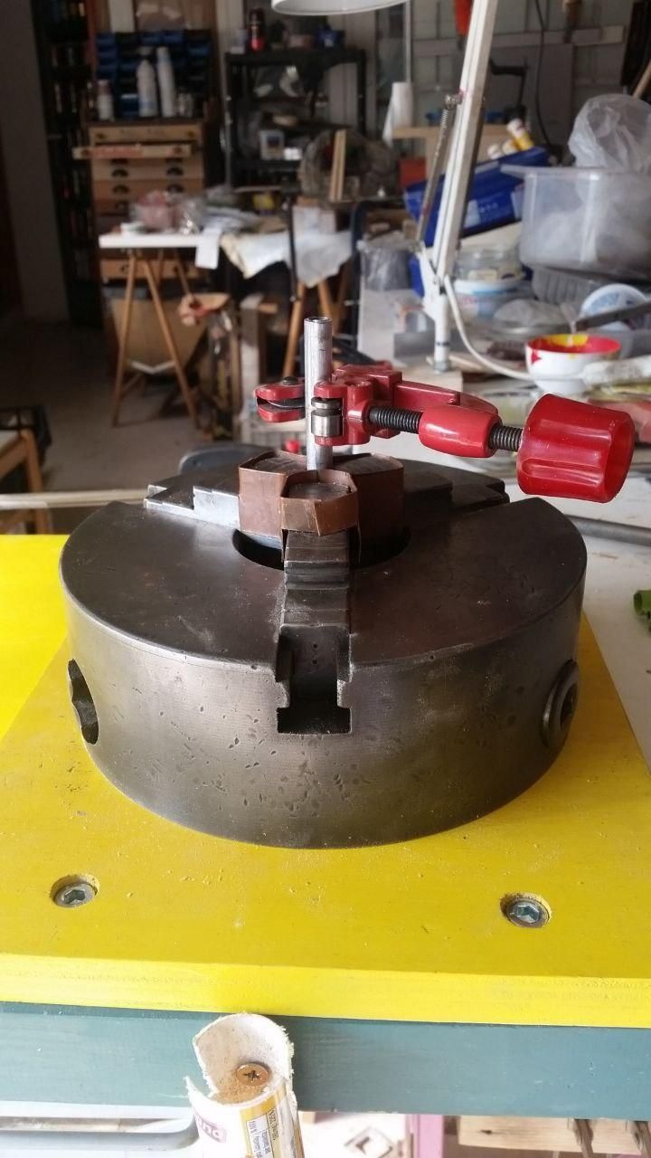 A piece of pipe held by a 3-jaws chuck to be cut