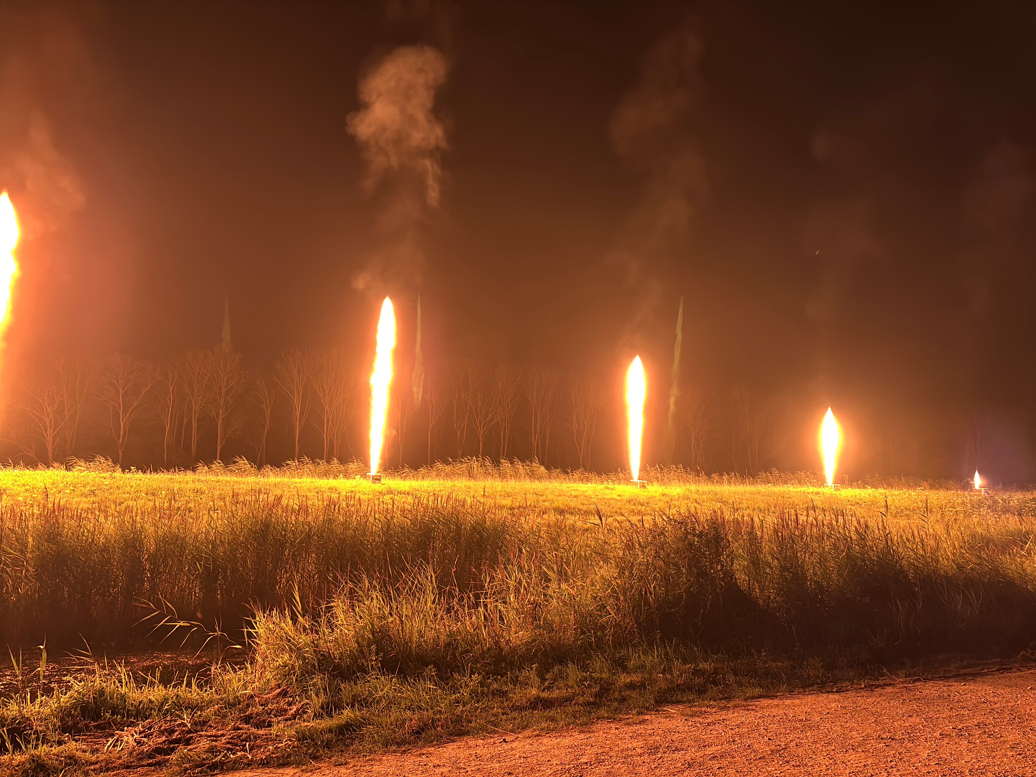 Some columns of fire being ejected from small points in a line next to each other