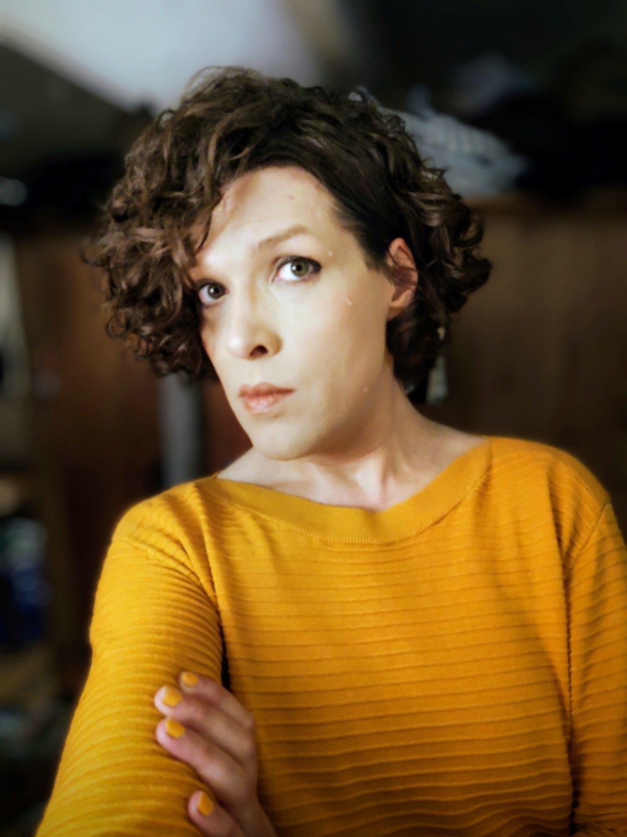 Sweaty selfie in a yellow shirt, with orange/yellow nail polish.