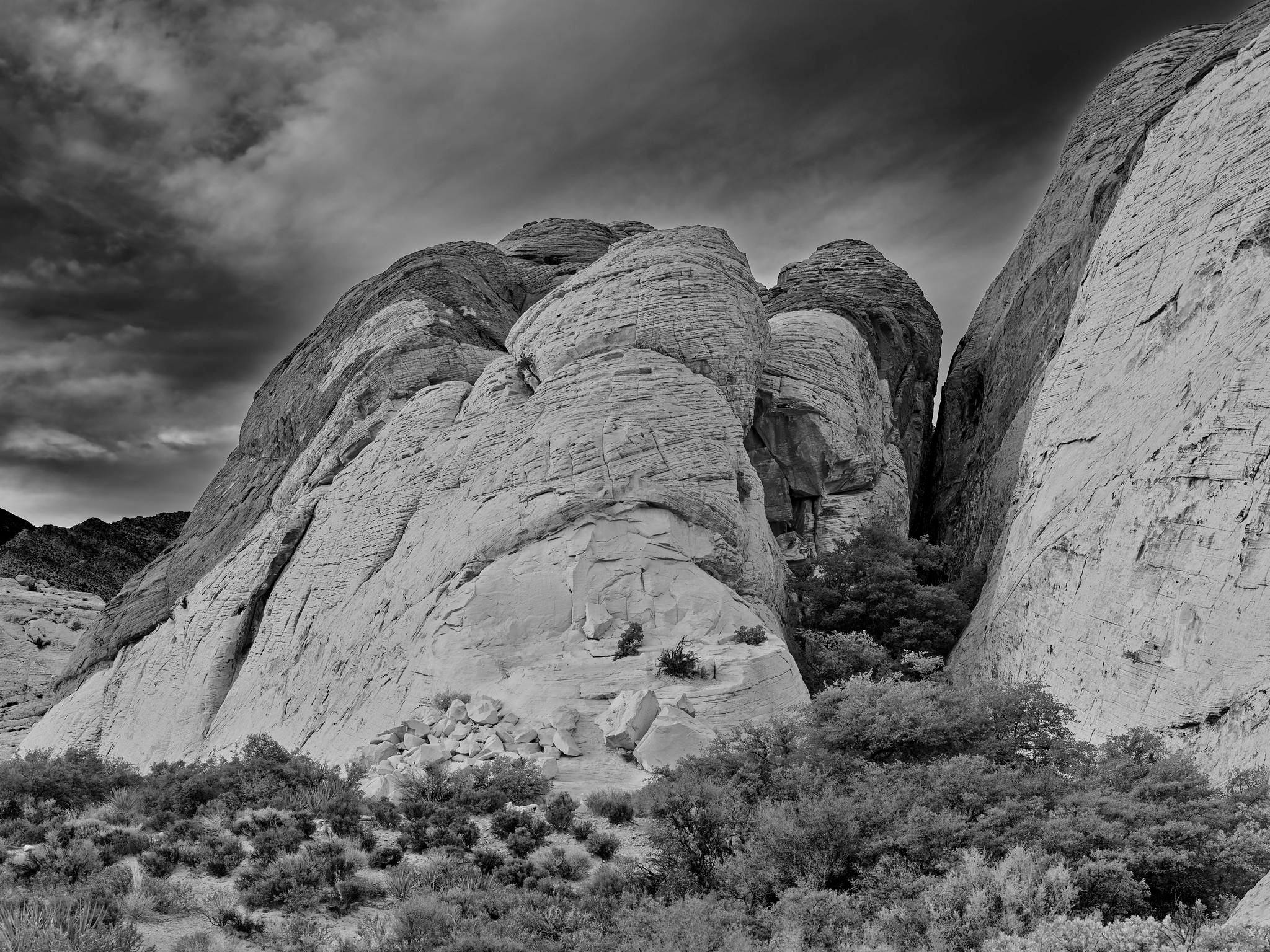 Sandstone hills, showing different shades, against a partly cloudy sky.