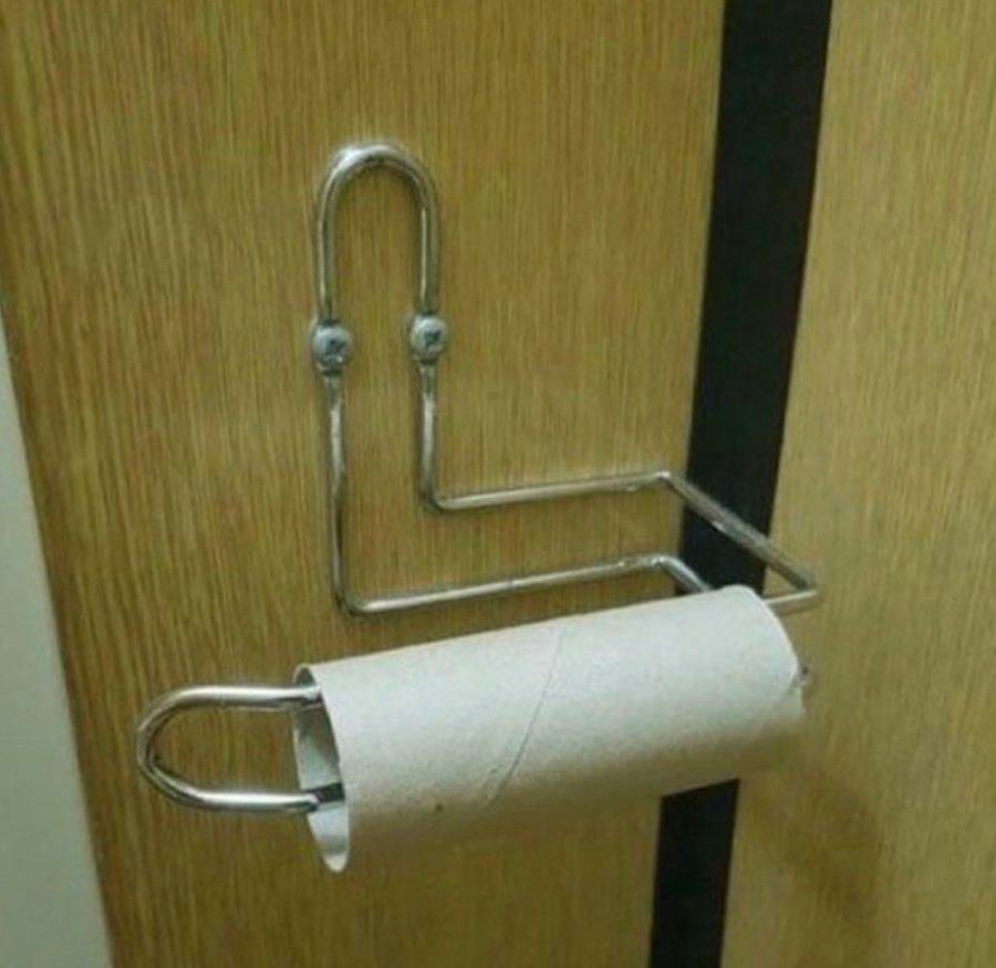 A photo of a toilet roll holder very much in the shape of Clippy, Microsoft's assistant and precursor to AI