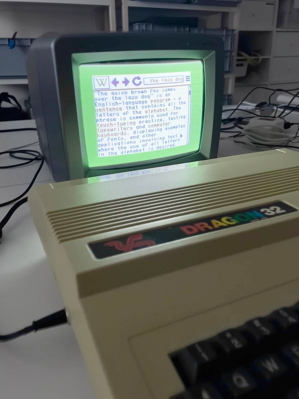 A photo of a CRT monitor displaying a (mock up) Wikipedia browser in a really low resolution.