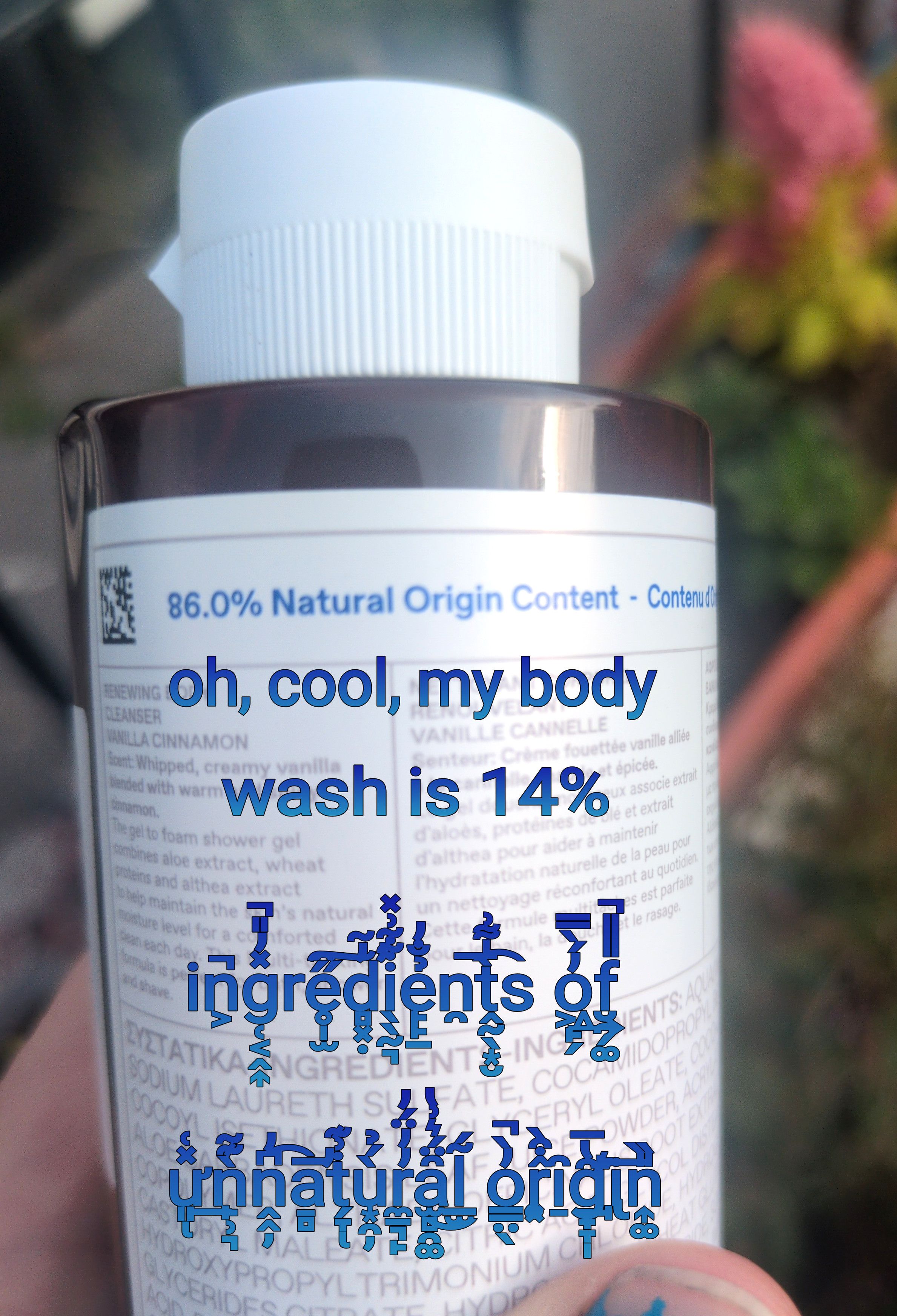 A bottle of body wash, proclaiming itself to be "86.0% natural origin content". Below it, macro text tags "oh cool, my body wash is 14% ingredients of unnatural origin". The last four words are in a creepy "Zalgo text"
