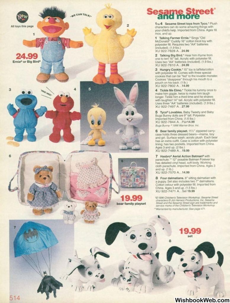 Alt text: A 1996 J.C. Penney catalog page showing a variety of toys: Talking Farmer Ernie, Talking Big Bird, Hungry Cookie Monster, Tickle Me Elmo, Baby Tweety, Baby Bugs Bunny, a bear family playset with two cubs and a carry case, a small patterned toy suitcase, a Hasbro Aerial Action Batman with parachute, and a plush set of three dalmatian puppies.