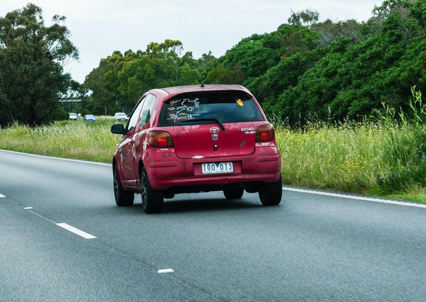 Red Toyota Echo that's seen better days