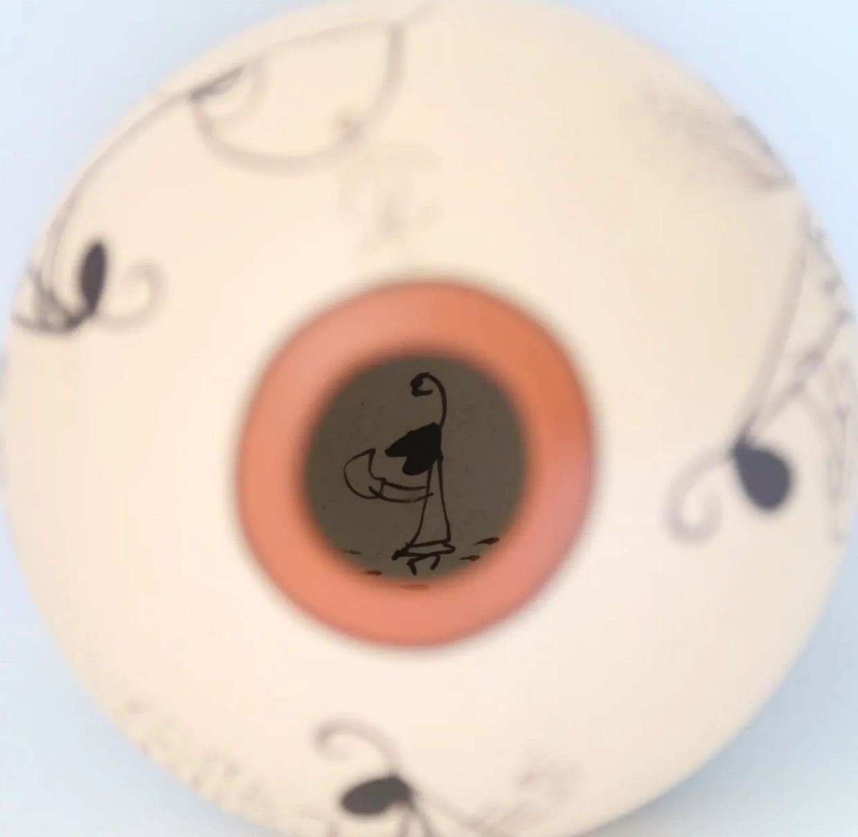 When you look inside the vase you see the ant eating the tortilla. 