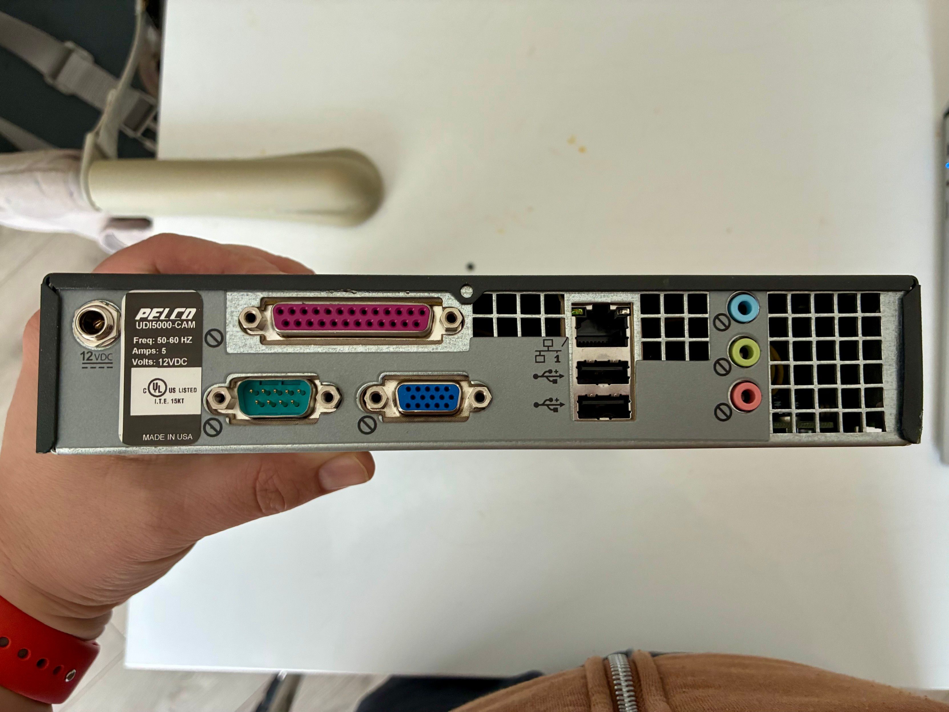 The back of the device. Standard pc ports, some with a 🚫 sign. 