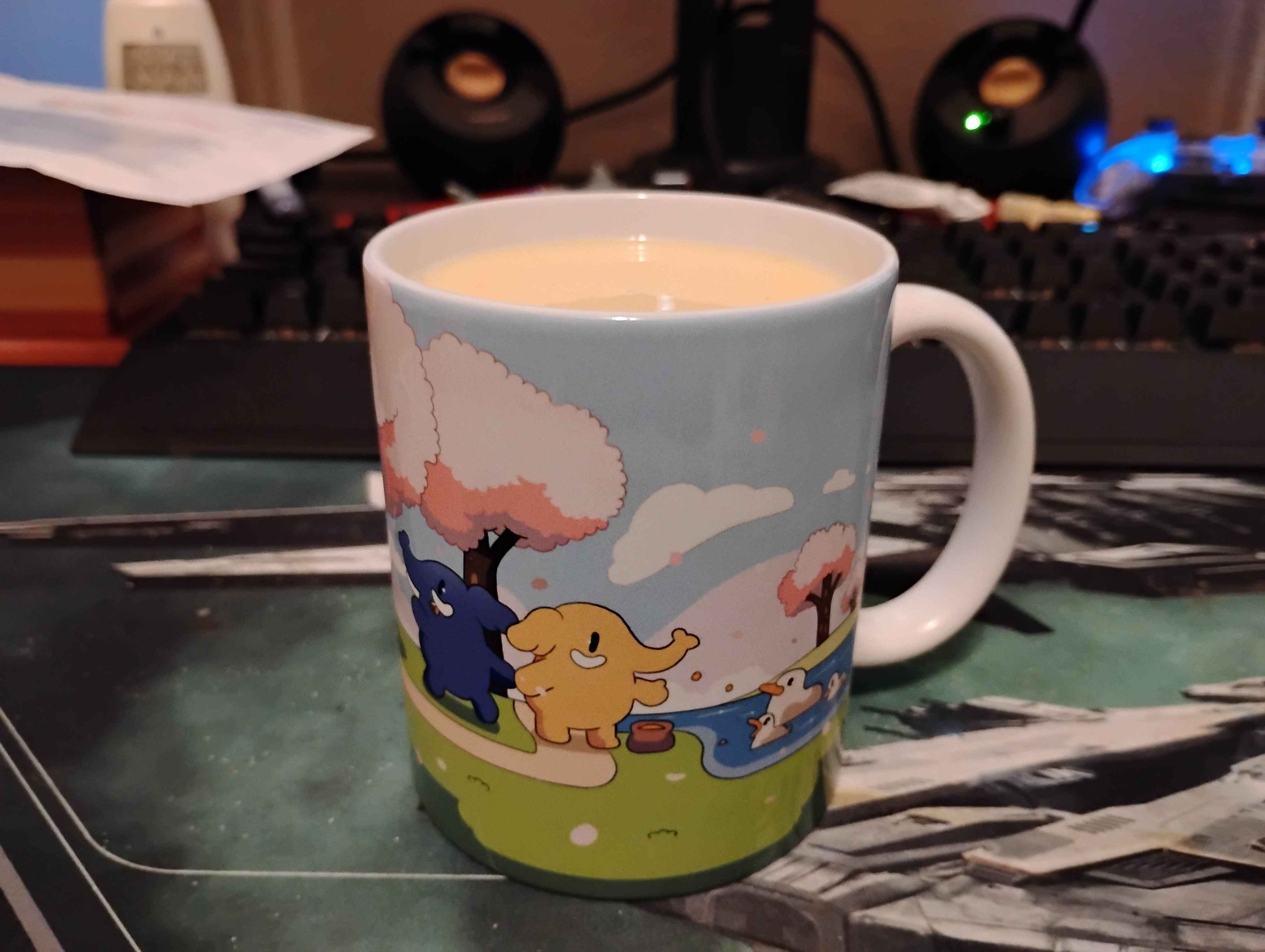 Image of a coffee or tea cup showing off one side of the Mastodon Cherry Blossom Mug filled with eggnog.