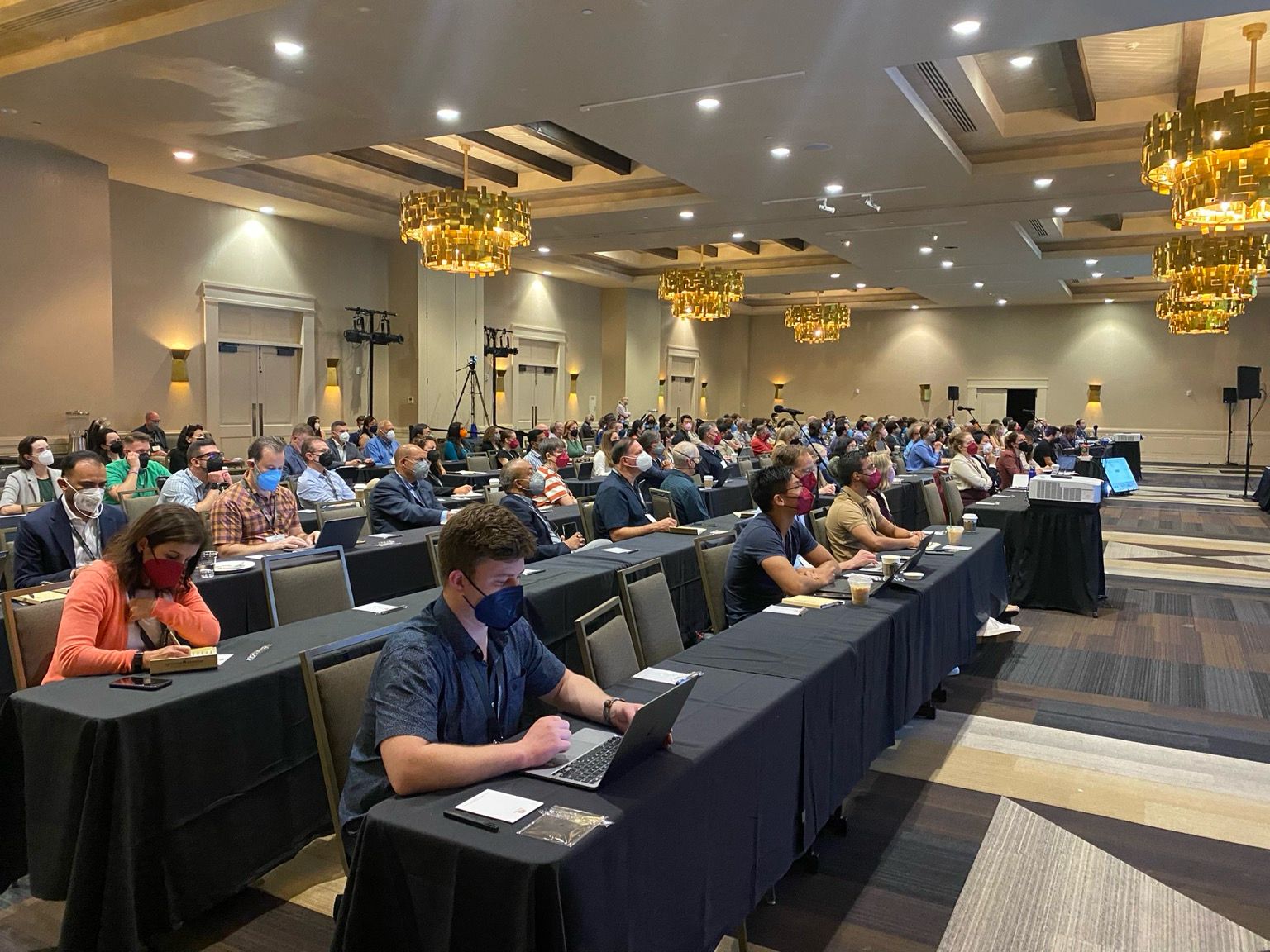 Audience for a Long COVID conference all wearing masks