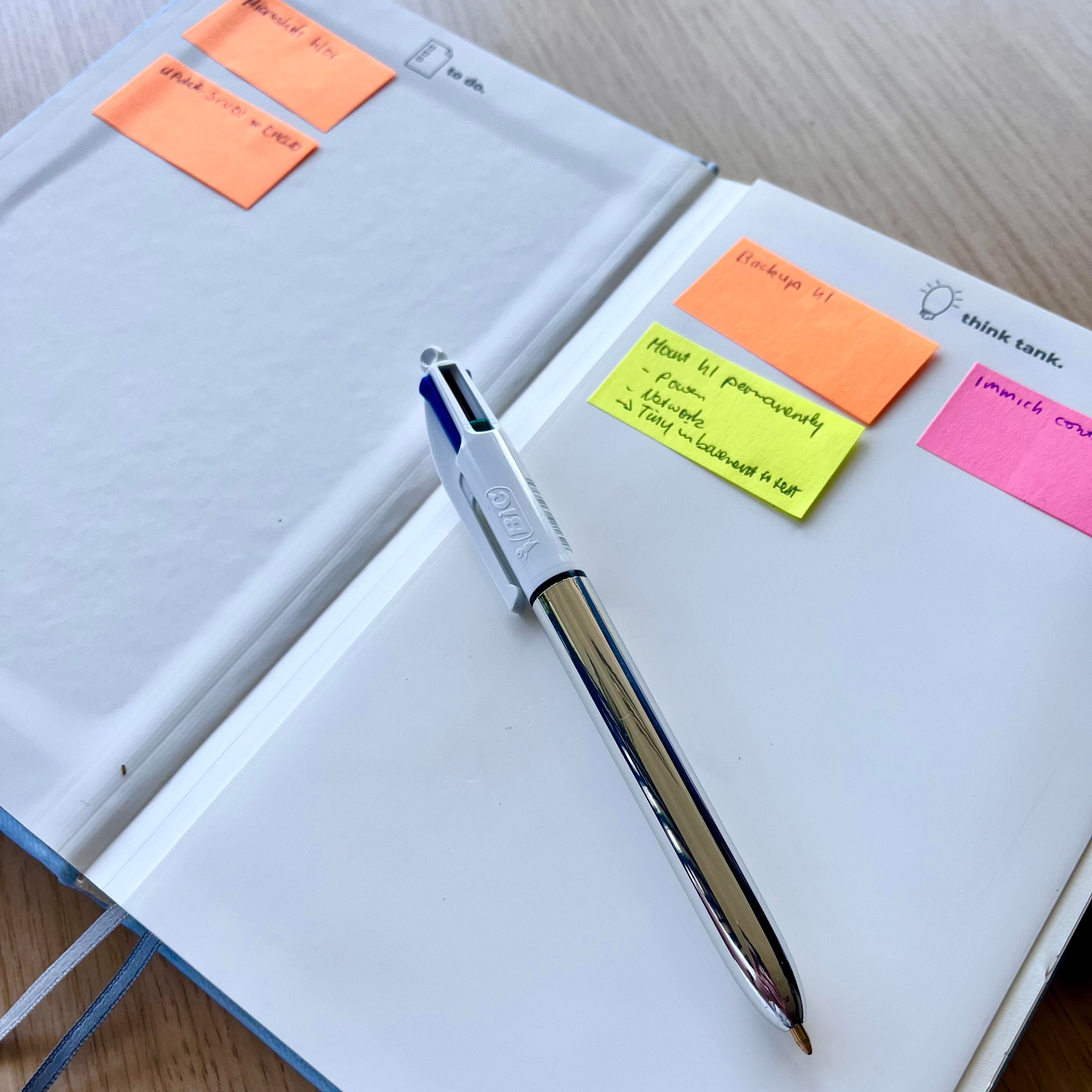 My Zettelweise notebook on the Kanban page with some post-its and my shiny BIC 4 colour pen