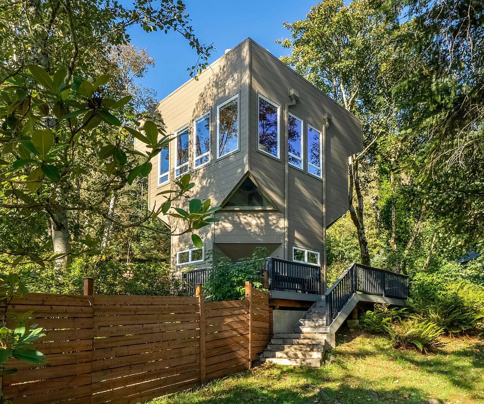 A bizarrely shaped 3 story house. It comes to a point in the middle with a triangle window in the centre and the lower floors are smaller than the upper floors. It looks a bit like a helmet but angular.