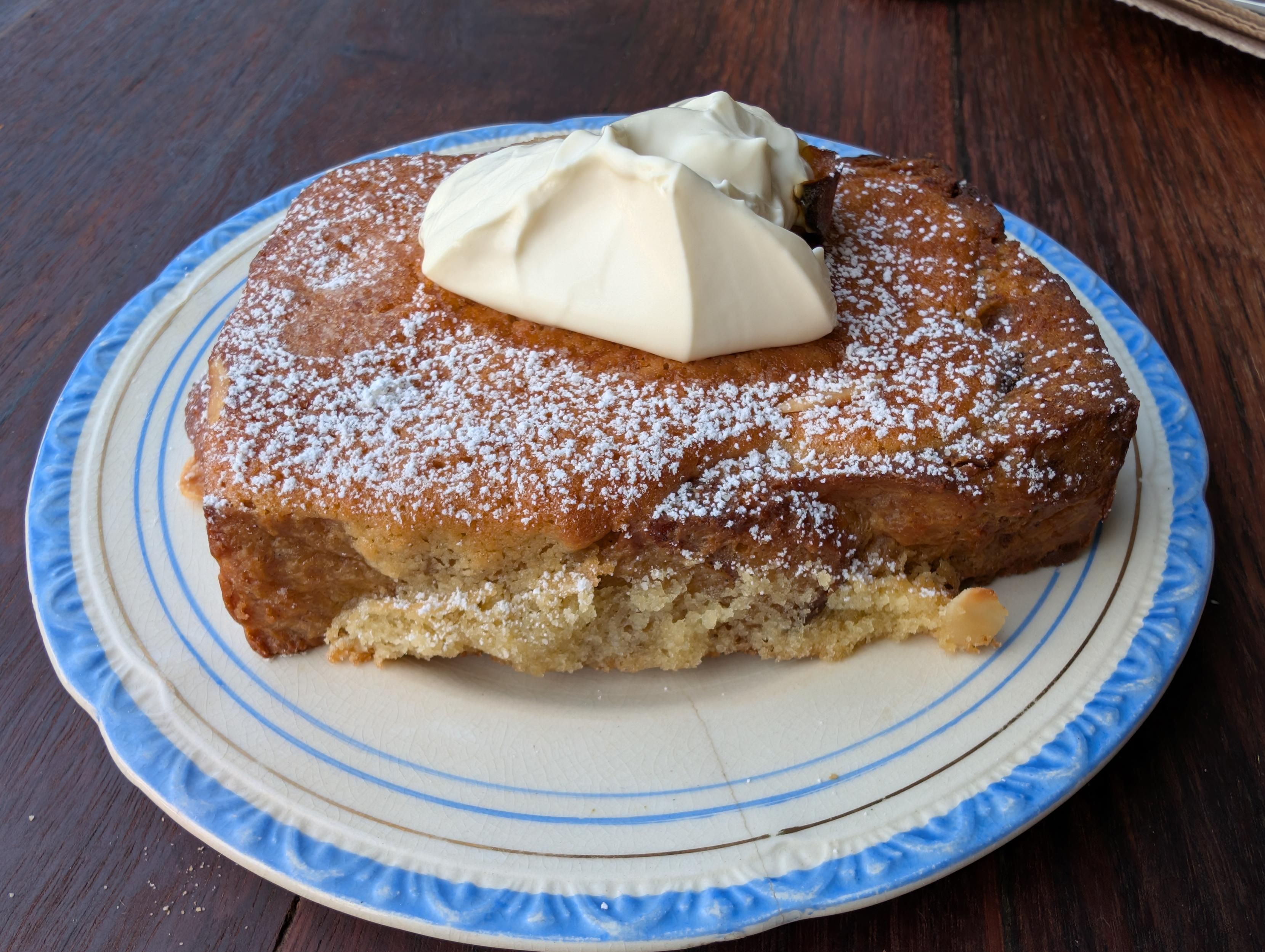 Boston brioche with apple, in a rectangle shape with apple and a dollop of cream