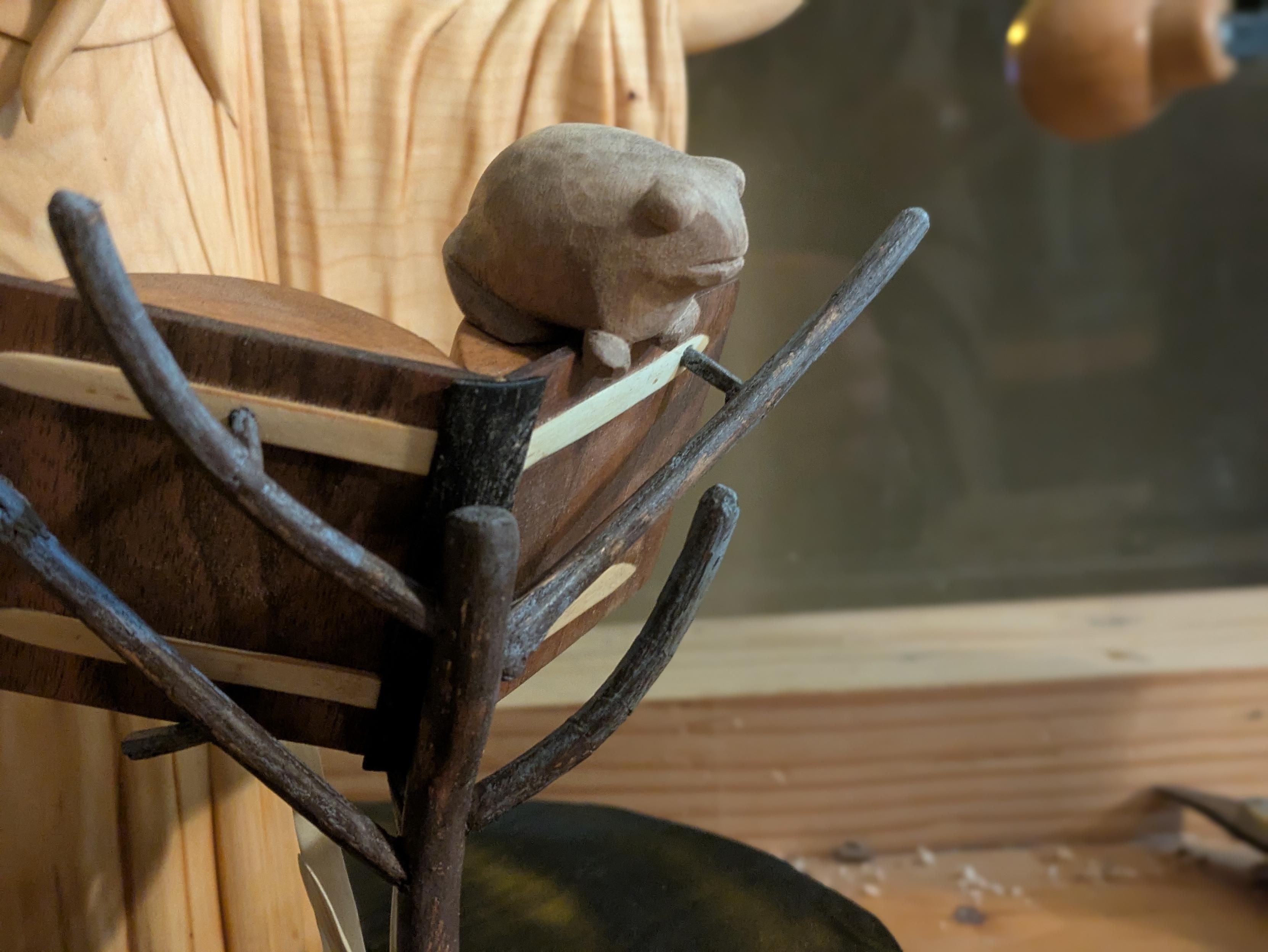 Draft of a frog on the upper part of an open book, itself on a branch holding it in front of not seen entirely humanoid octopus wearing a dress, arms wide open