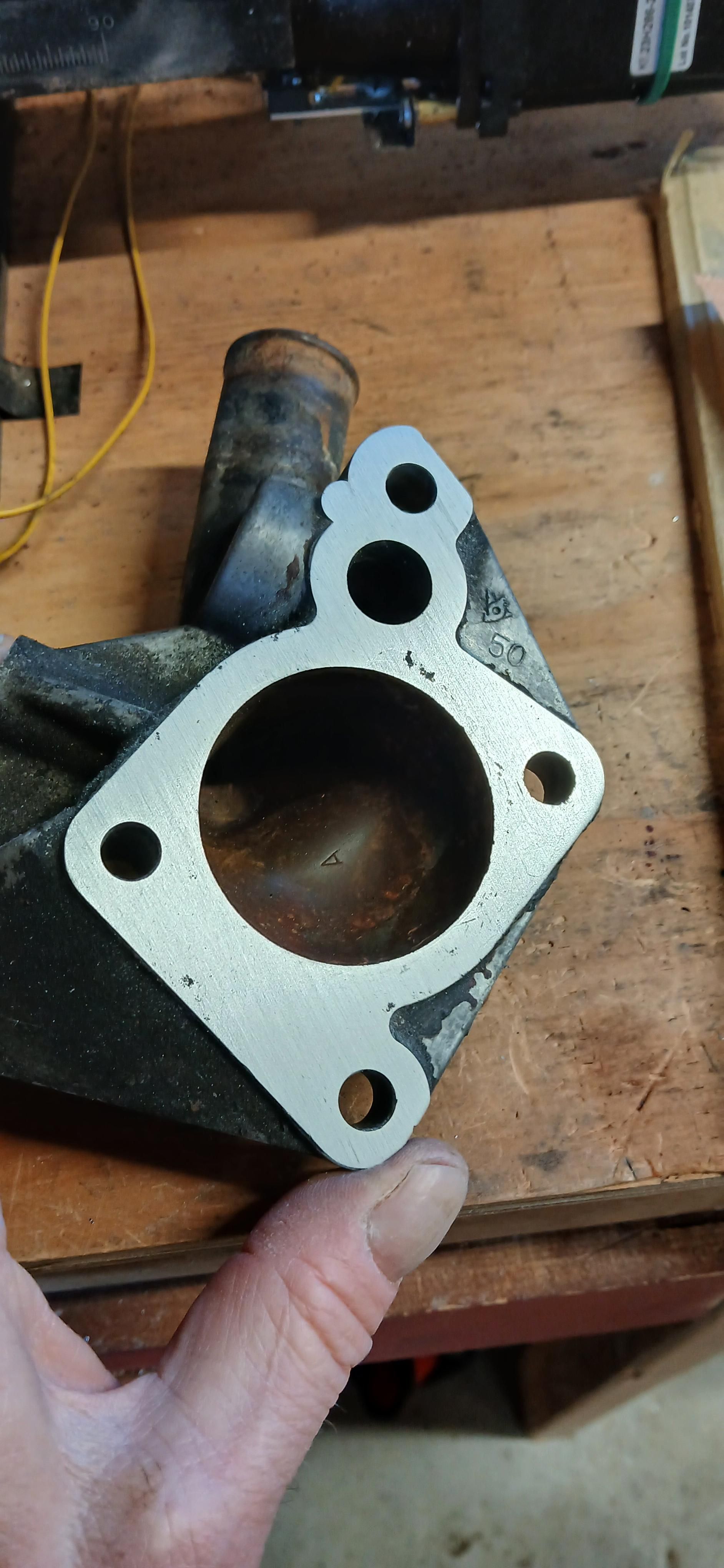 Shinier planar gasket surface on the aluminum thermostat housing 