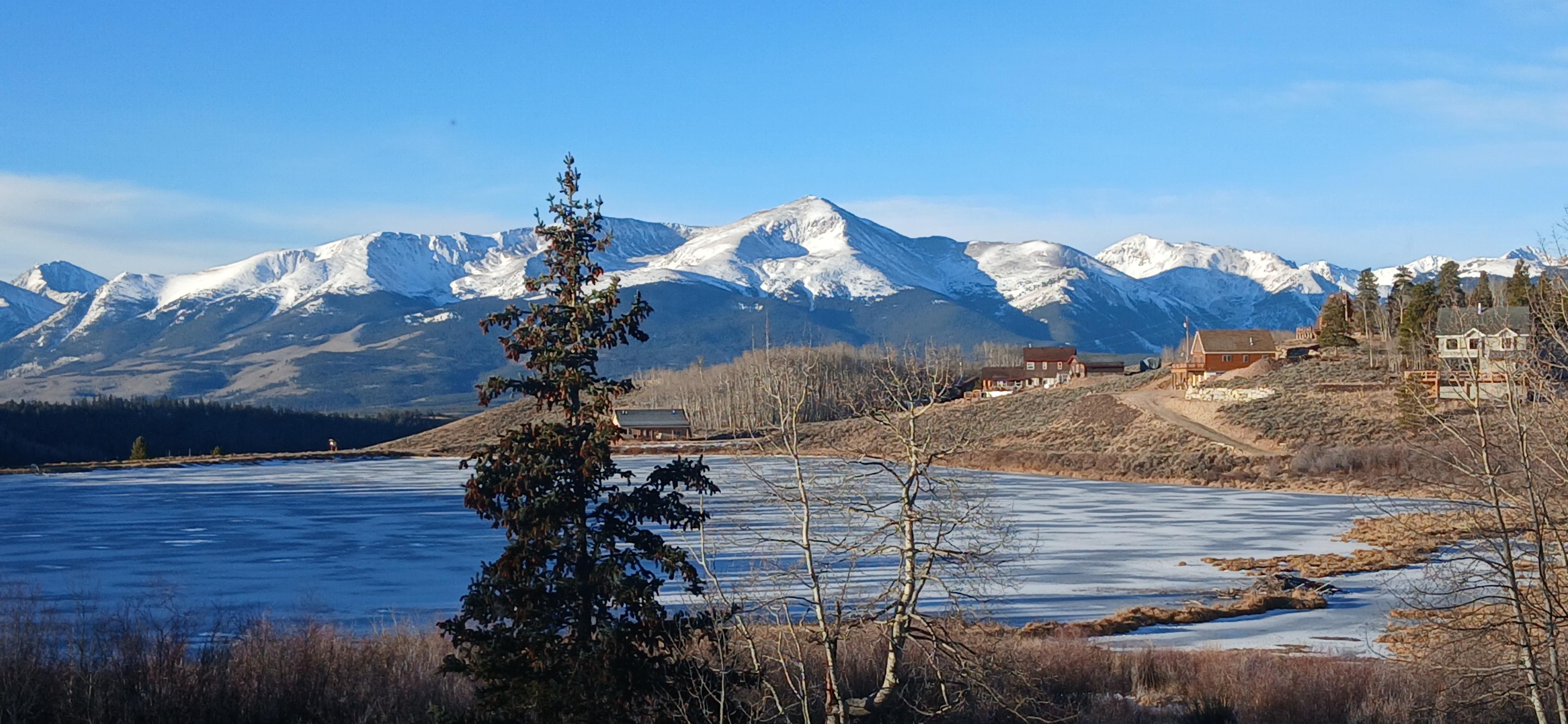 Icy lake with snowy mountains behind 