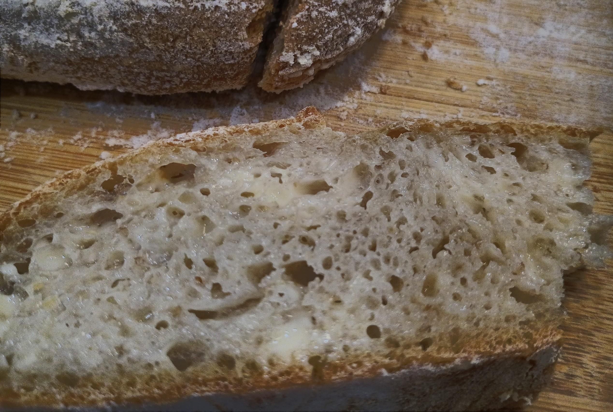 A butter-smeared slice of bread is a narrow and holey bit of tasty goodness.