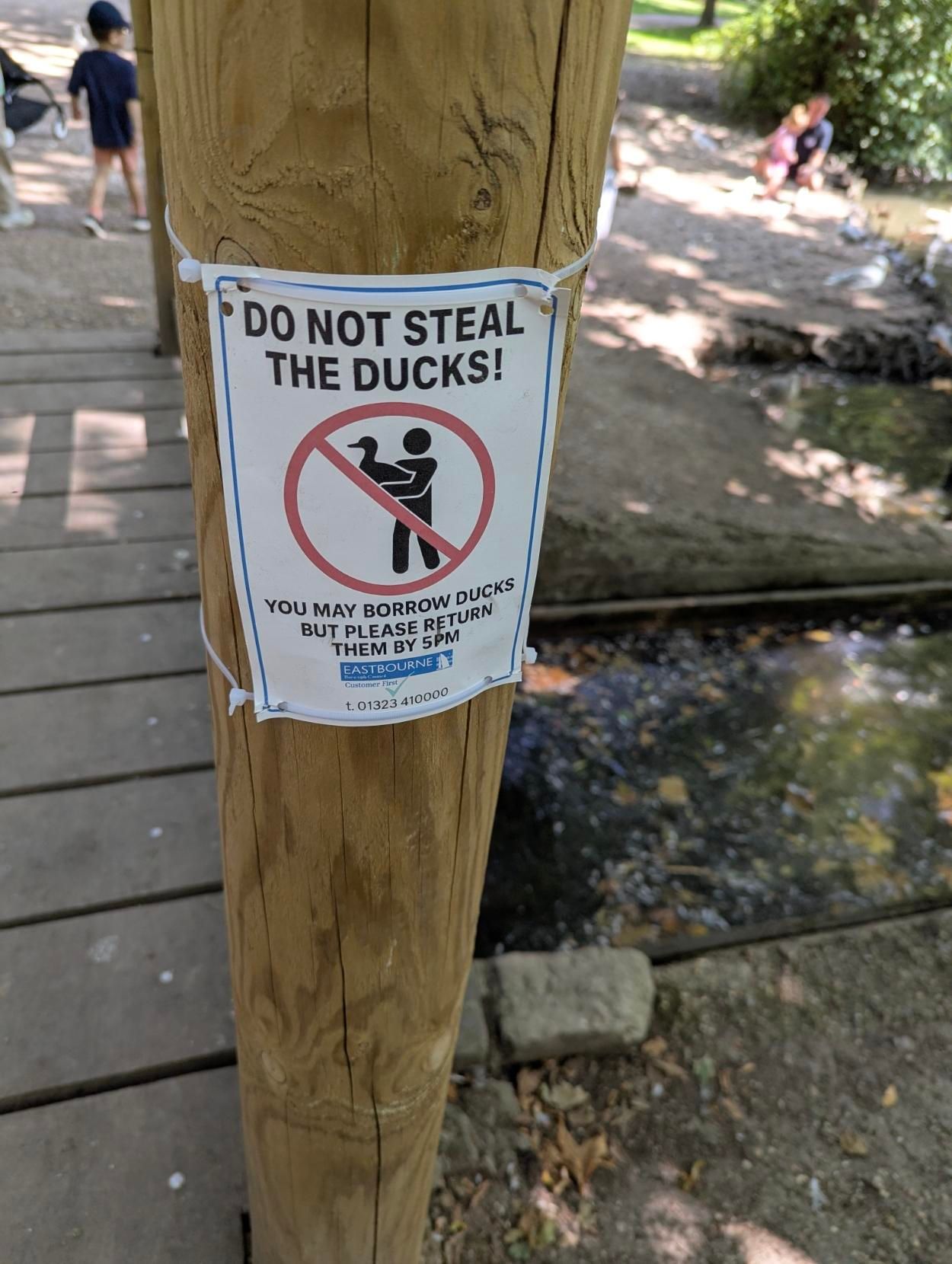 A sign which says Do not steal the ducks! You may borrow ducks but please return them by 5PM