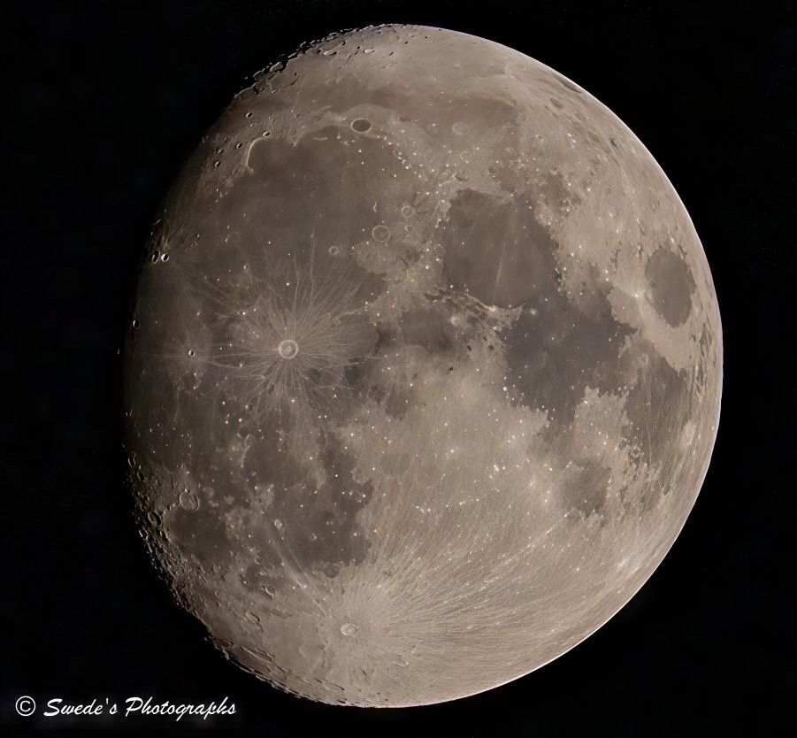 "The Moon fills the frame in stunning clarity, its cratered surface etched with the scars of ancient collisions and cosmic time. Each crater tells a story—some small and shallow, others vast and deep, with bright rays of ejecta radiating outward like frozen explosions. The texture of the lunar surface is rough and pitted, resembling weathered stone or the surface of a forgotten planet, untouched by wind or water.

Shadow and light play across the terrain, revealing ridges, basins, and subtle variations in elevation. The image captures the Moon not as a smooth orb in the sky, but as a rugged, complex world—silent, airless, and hauntingly beautiful. Its grayscale palette enhances the sense of timelessness, as if the Moon exists outside the reach of seasons or decay.

The photograph, signed “Swede’s Photographs” in the bottom left corner, offers more than a view—it invites contemplation. This is Earth’s only natural satellite, seen not as a distant glow, but as a textured relic of the solar system’s ancient past." - Copilot
