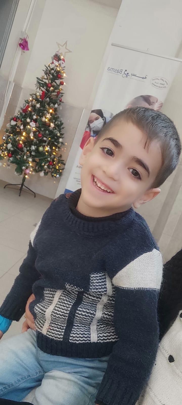 Walid smiles while waiting for his therapy sessions at Princess Basma Center for the Rehabilitation of Children with Disabilities.