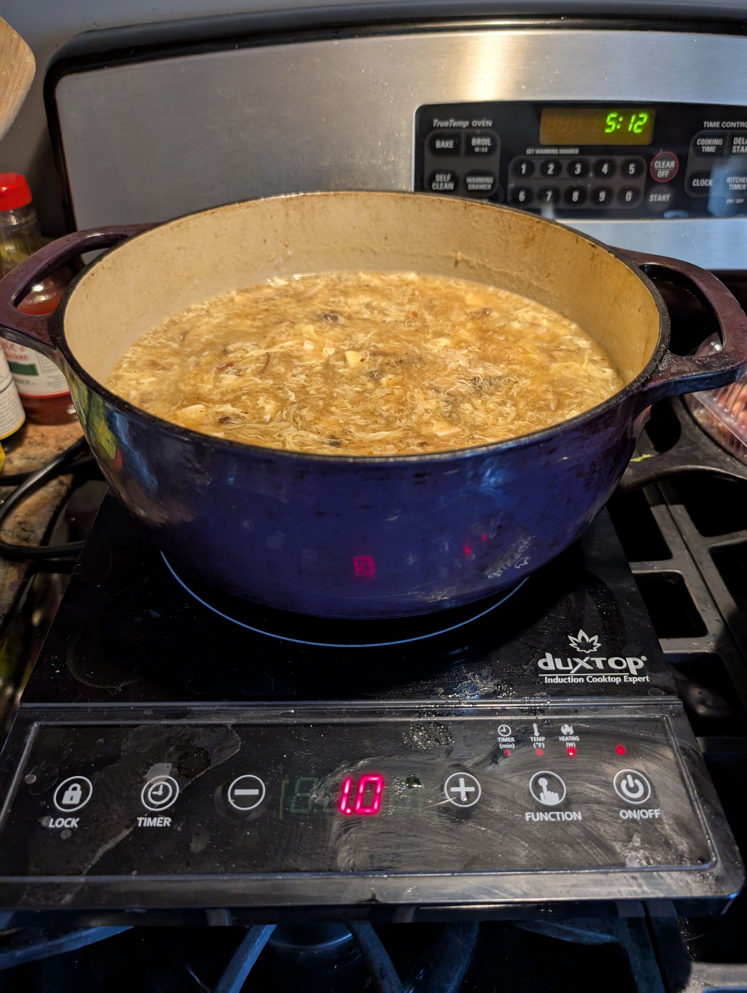 A pot of hot and sour soup in a dutch oven on an induction burner.  It makes soup making in the summer far more tolerable