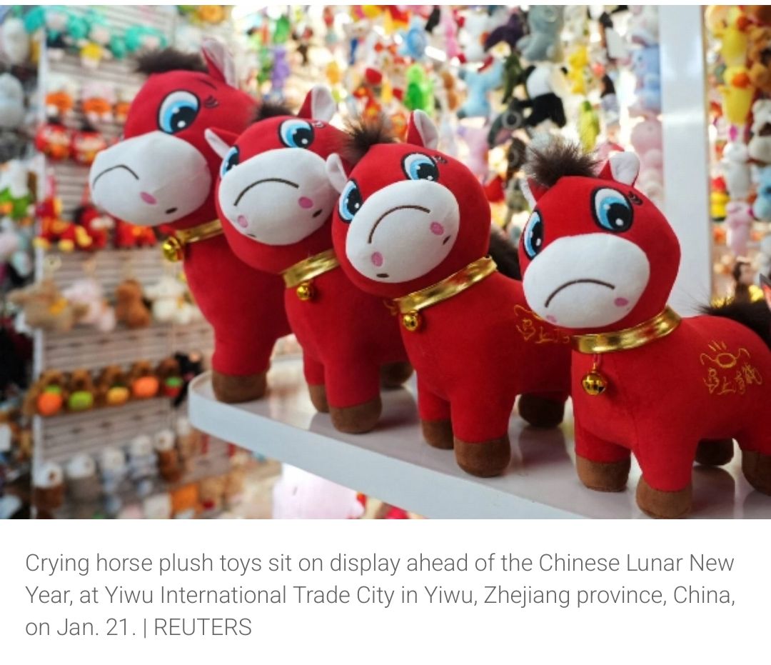 A set of four plushie red horses with big frowns are displayed on a shelf (Reuters photo in Japan Times)