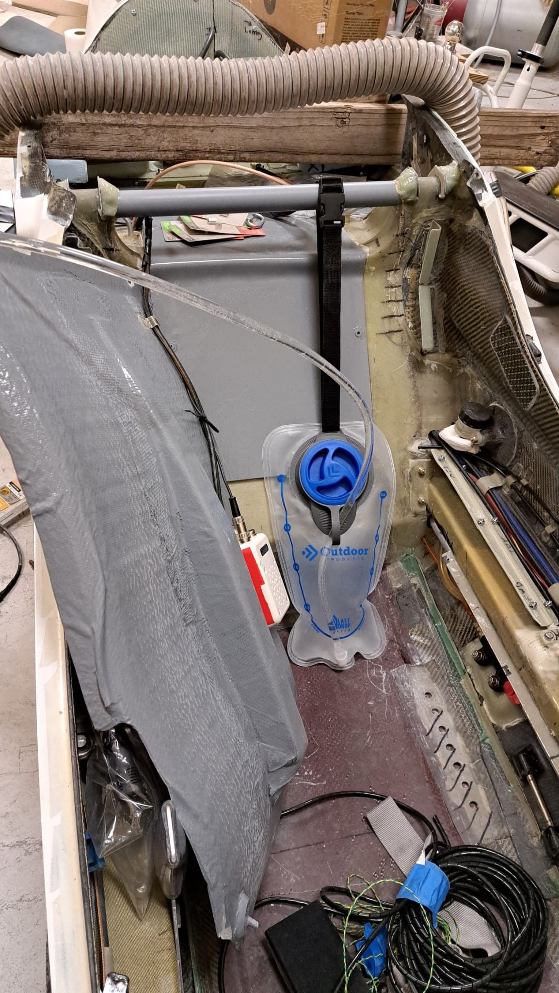 There is room behind the seat pan for a decent amount of drinking water. Only the drinking tube will be visible once the seat is back in place.