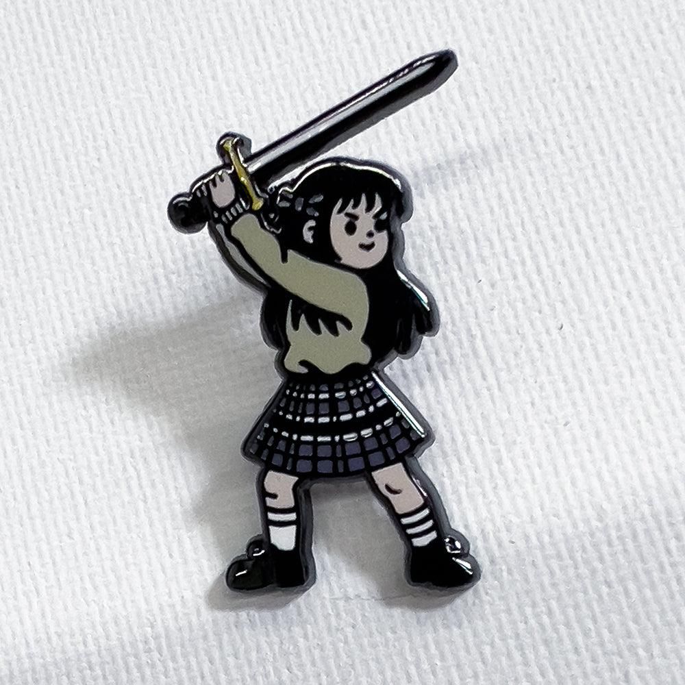 A pin of a girl weilding a sword.
