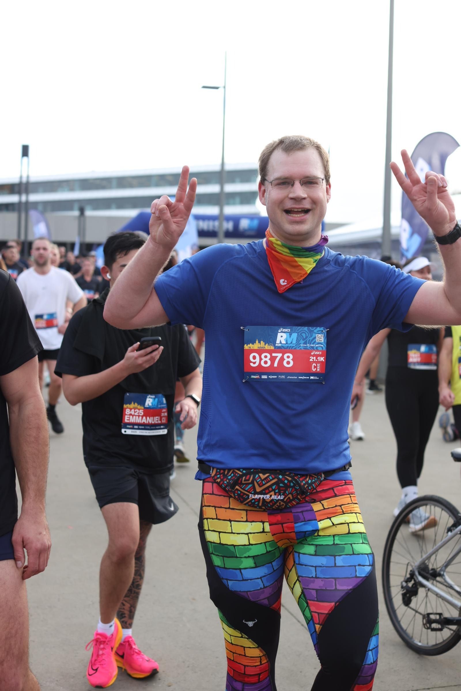 Picture of me after finishing a half-marathon. I'm wearing pride leggings and a pride bandanna.
