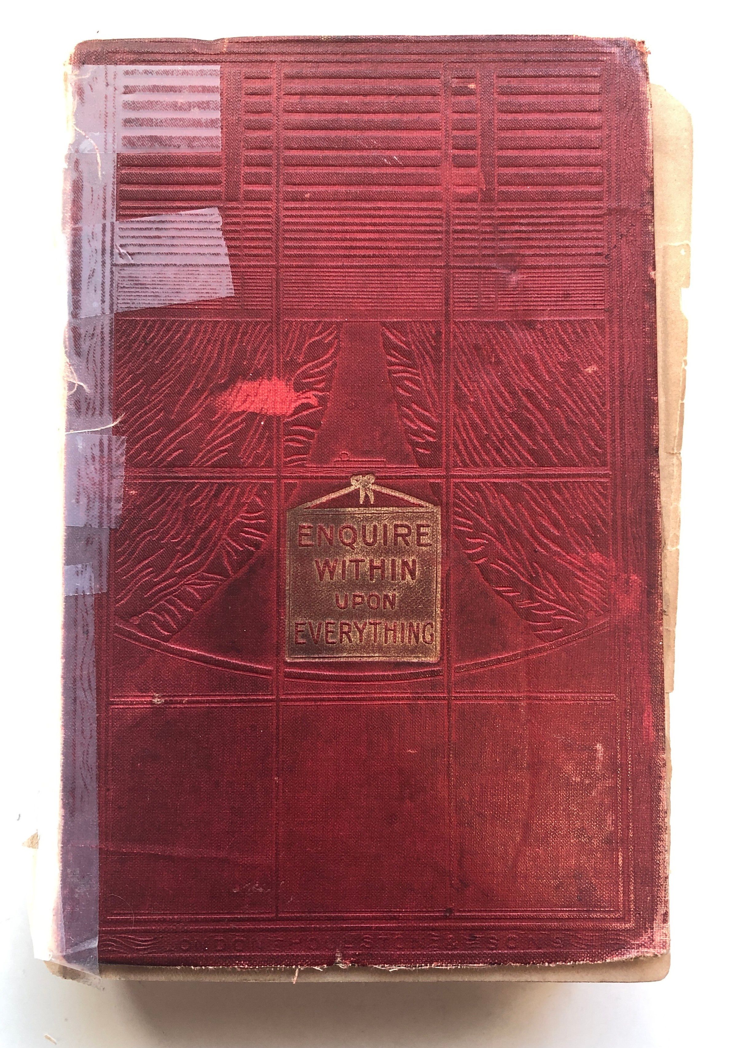 Photo of badly worn book cover, cover is red with the title Enquire Within Upon Everything in gold